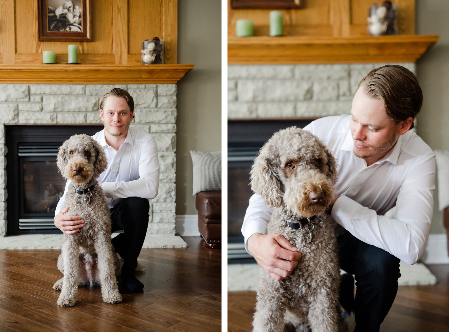 A fluffy goldendoodle dog sits with someone in a white shirt by a stone fireplace with wooden mantle.
