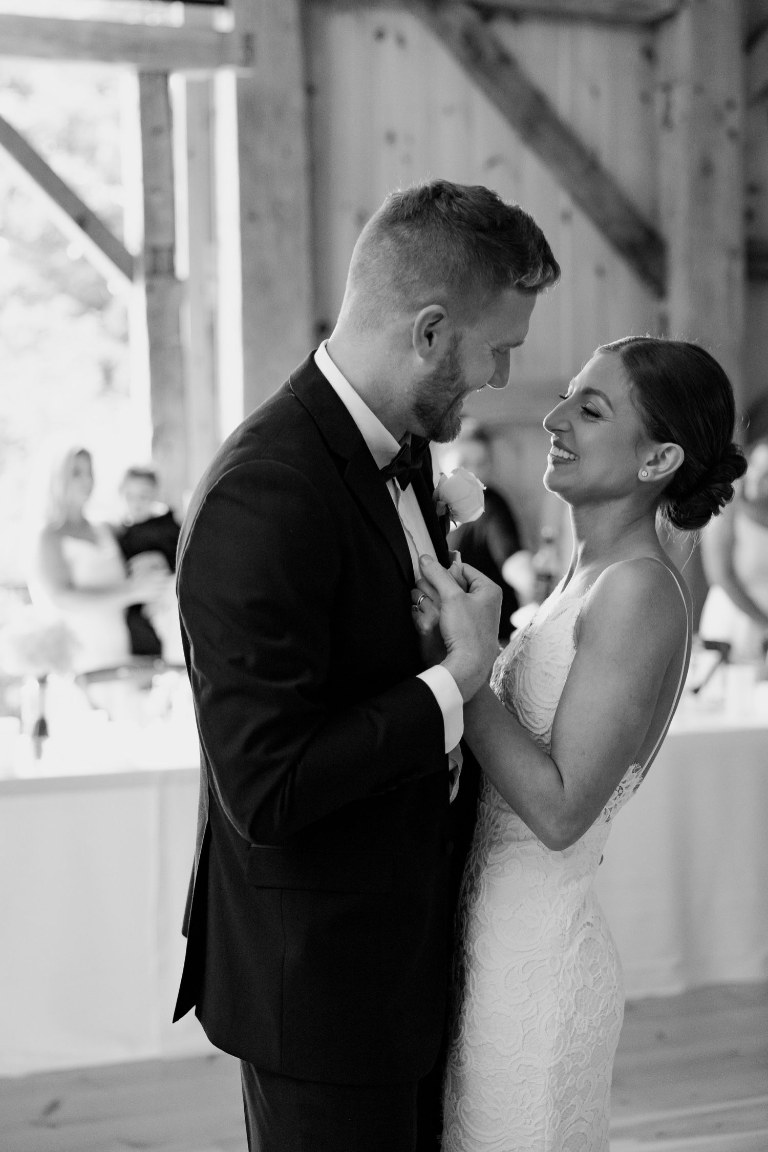 Romantic black and white portrait in rustic barn setting.