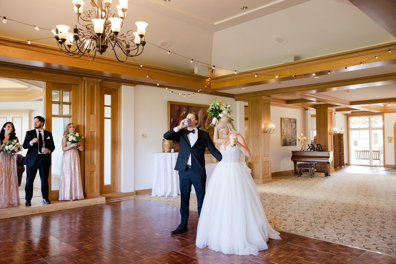 Elegant ballroom dance scene with chandelier lighting and wooden beam details.