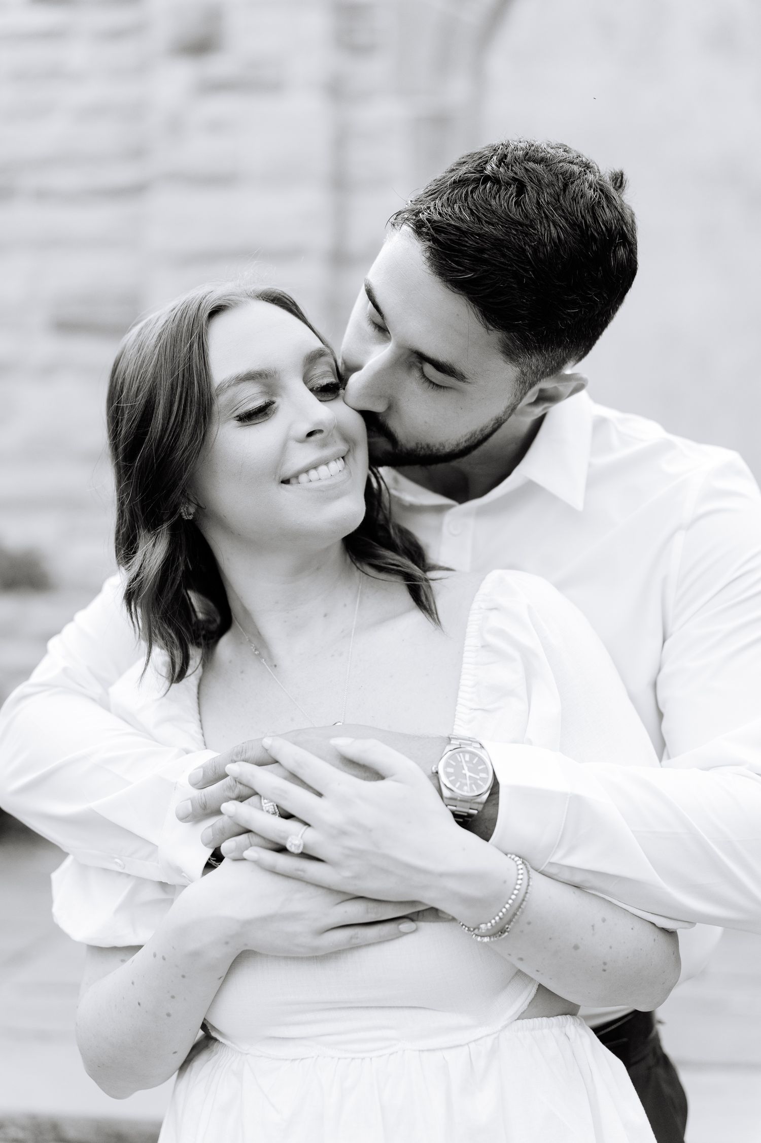 Black and white portrait of a couple sharing an intimate embrace.