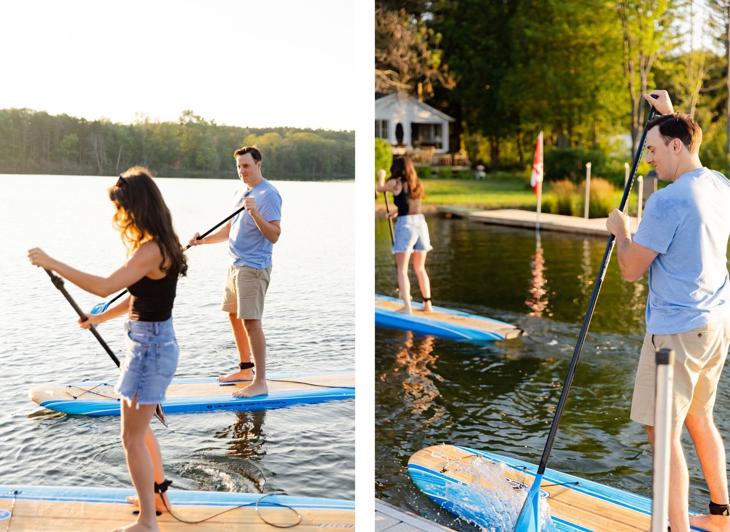 People learning to paddleboard on a calm lake near a wooded shoreline.