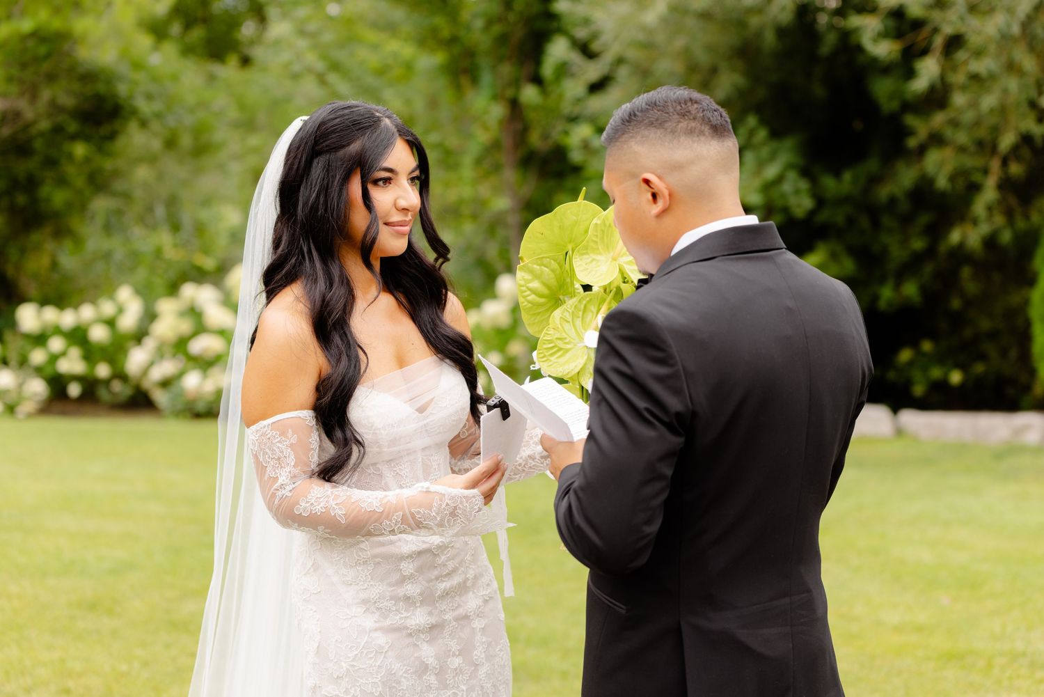 A romantic first look moment between newlyweds in a beautiful garden setting on their wedding day.