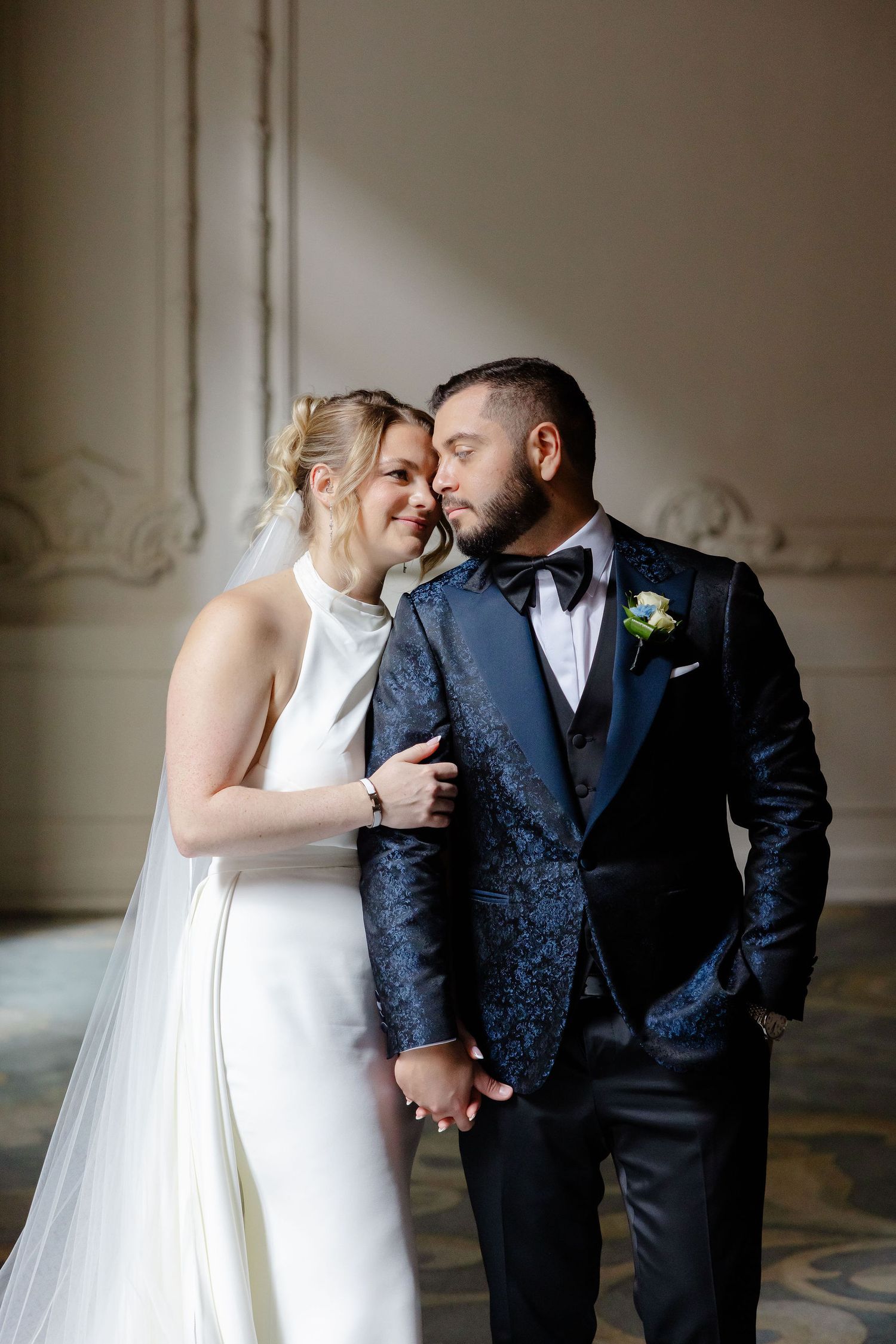 Tender wedding portraits showing sweet interactions between newlyweds in a classic indoor setting.