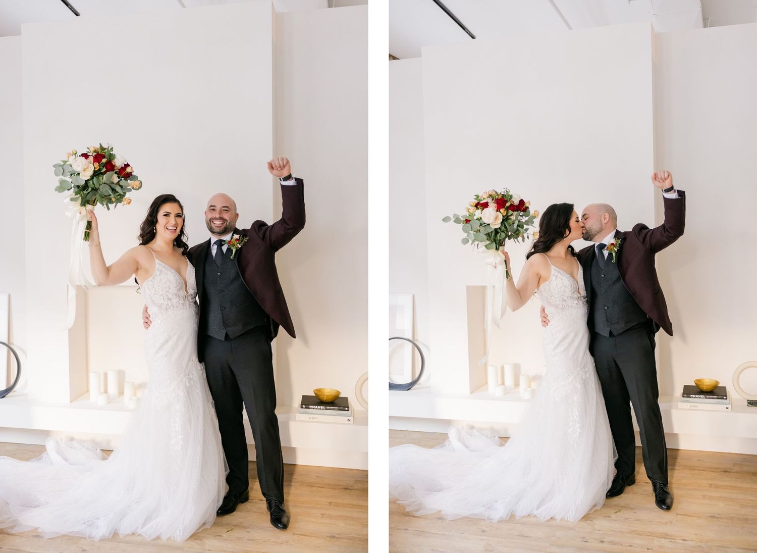 Joyful wedding couple celebrates with raised arms in bright indoor setting.