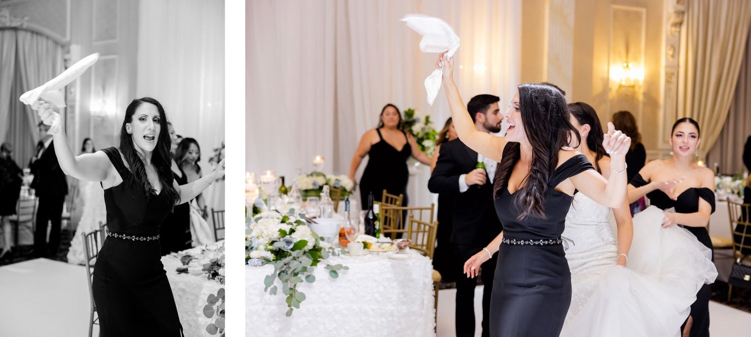 Wedding guests joyfully waving napkins during a celebration in an elegant ballroom reception venue.