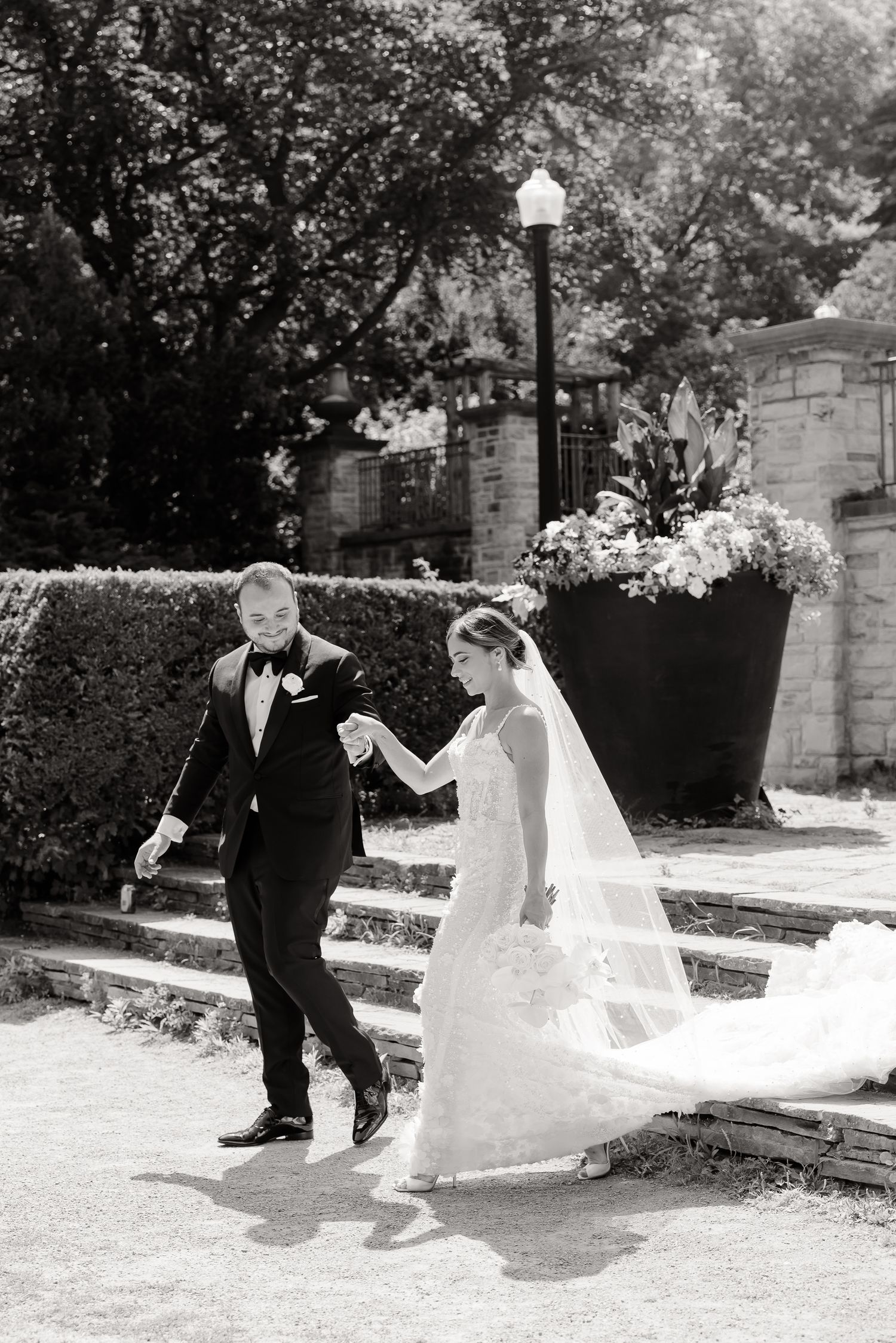 A joyful sequence shows a couple in formal attire playing and twirling together in a garden setting.