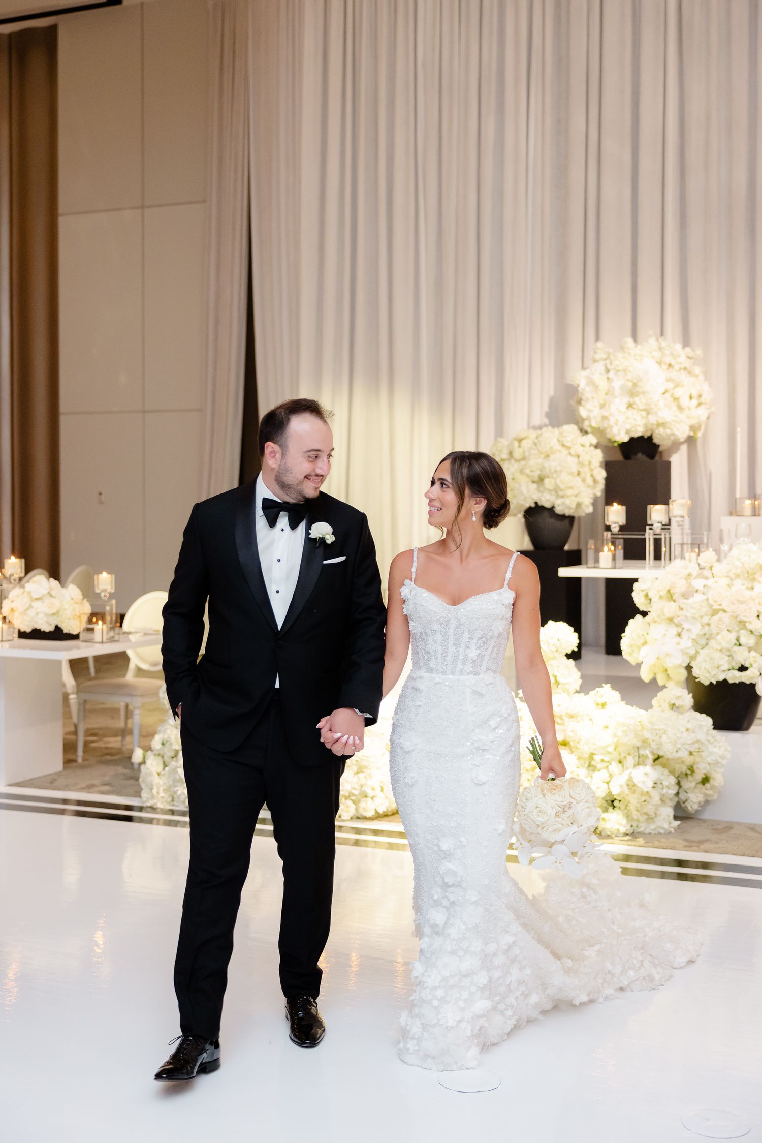 Candid moments of a joyful couple in black and white formal attire dancing and celebrating at an elegant wedding reception.