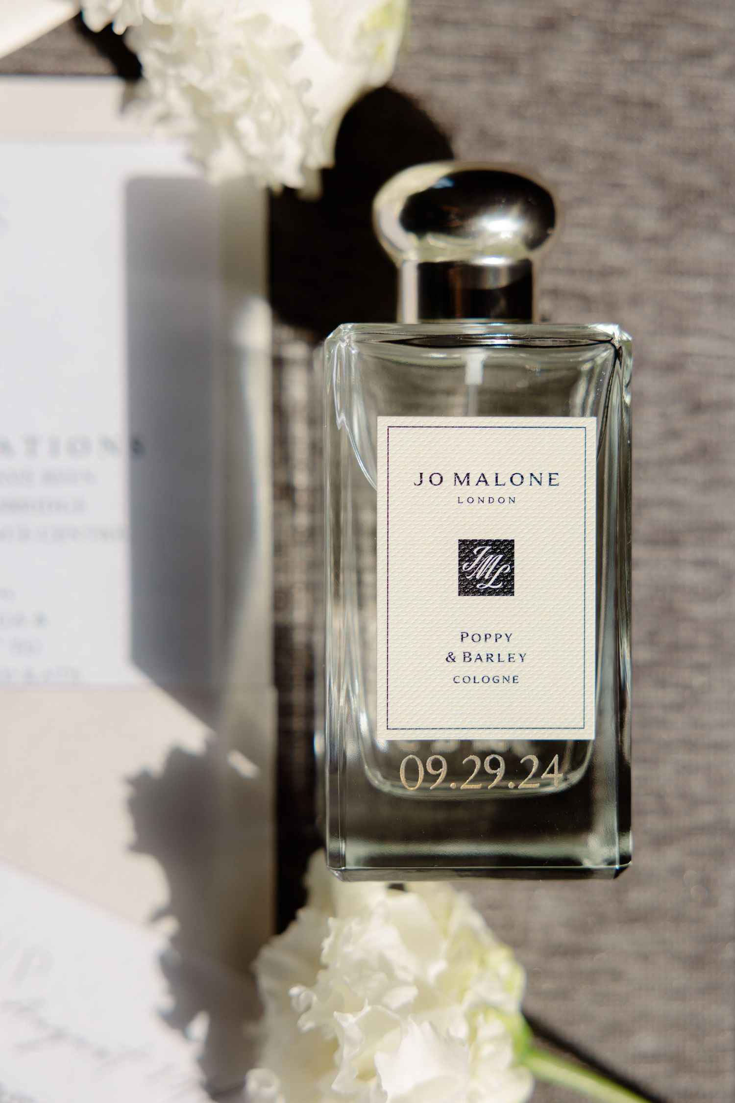 Jo Malone perfume bottle with white flowers and wedding date 09.29.24 engraved.