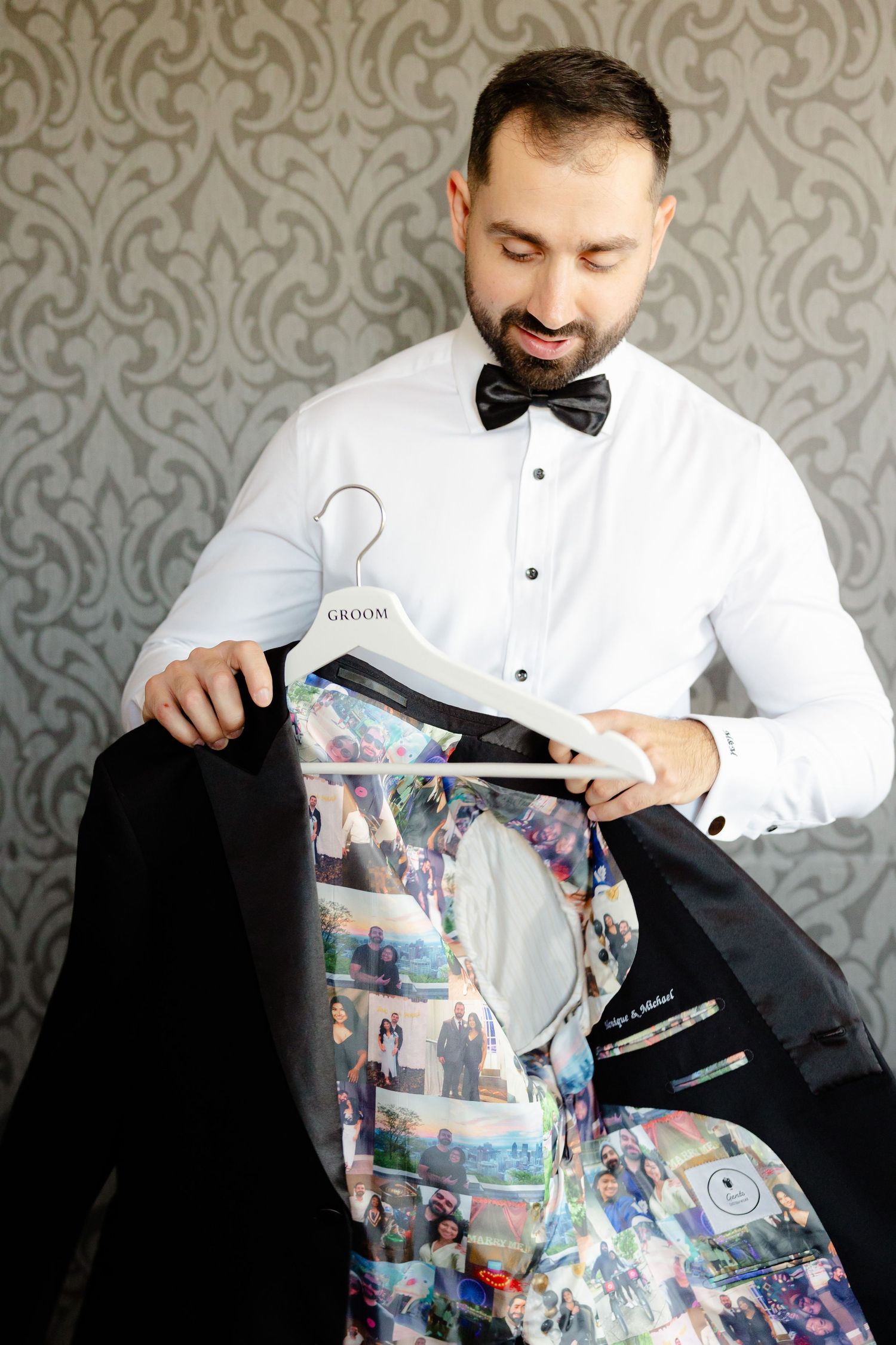 A groom examines the custom photo-lined interior of his formal black jacket.