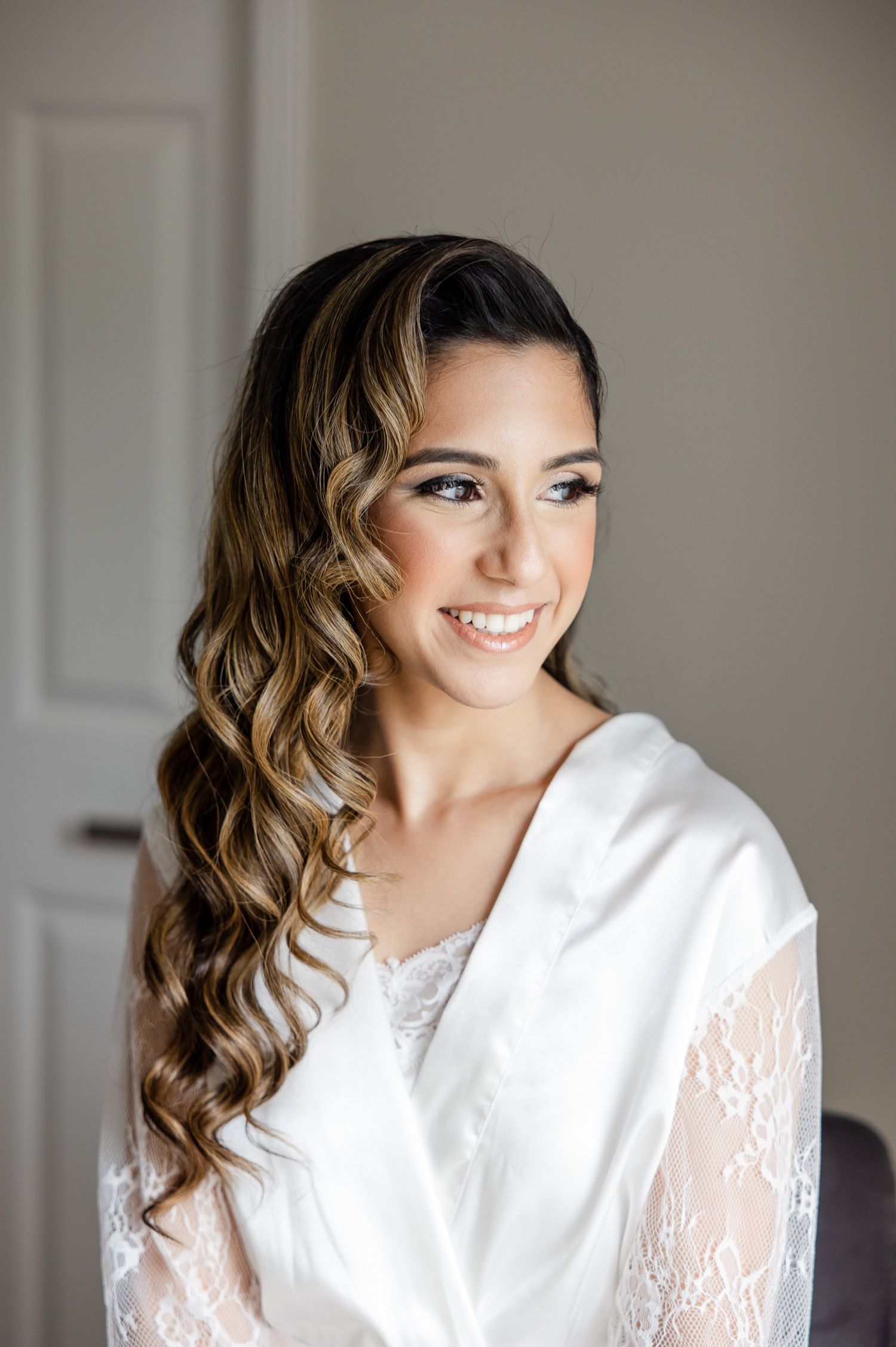 Bridal preparation photo with elegant hair and makeup styling.