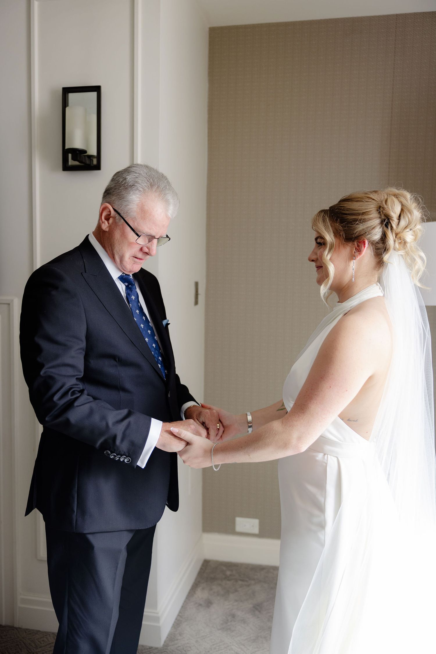 Series of first look moments between a couple in formal wedding attire.