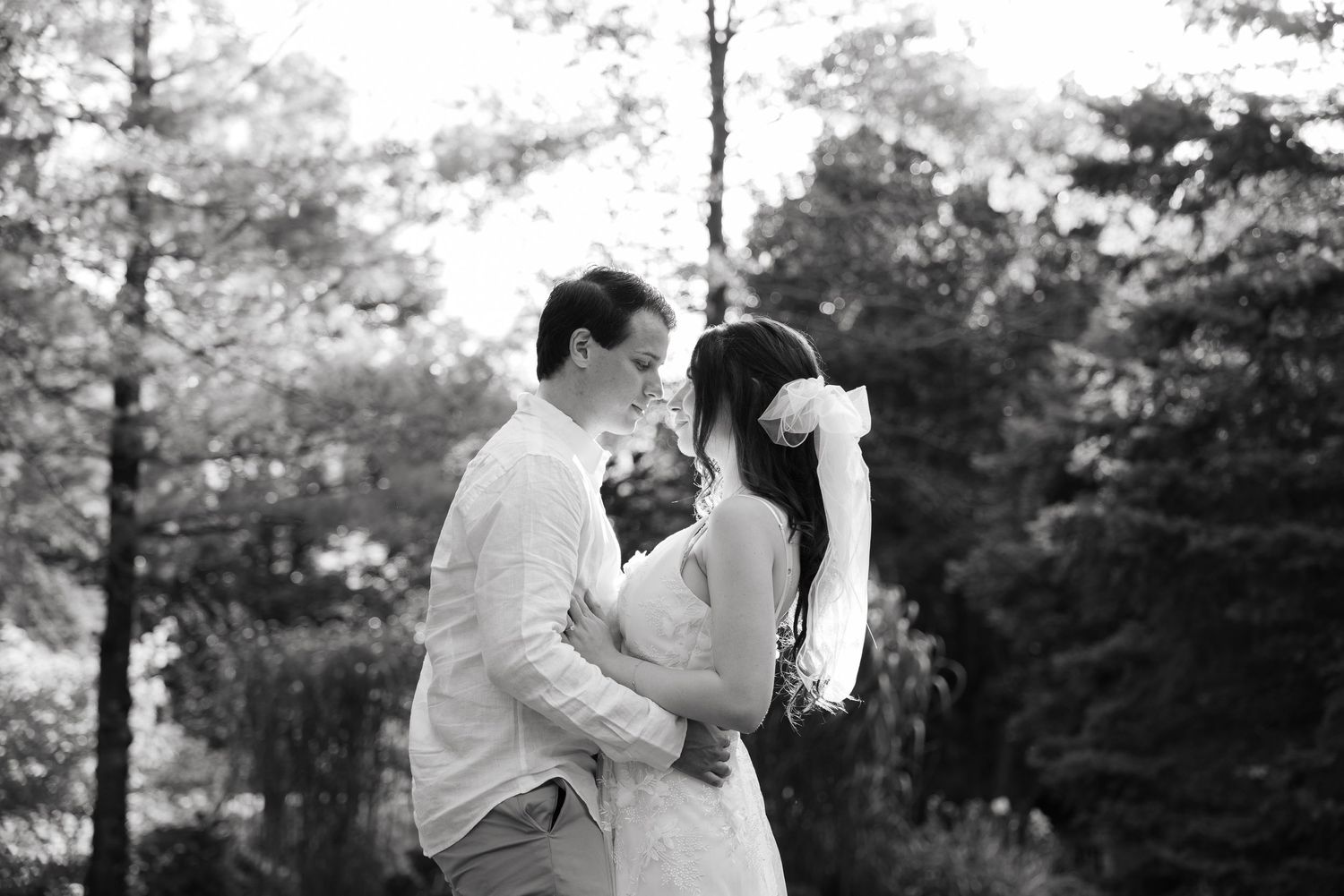 Intimate black and white wedding portrait showcasing a tender moment between the couple.