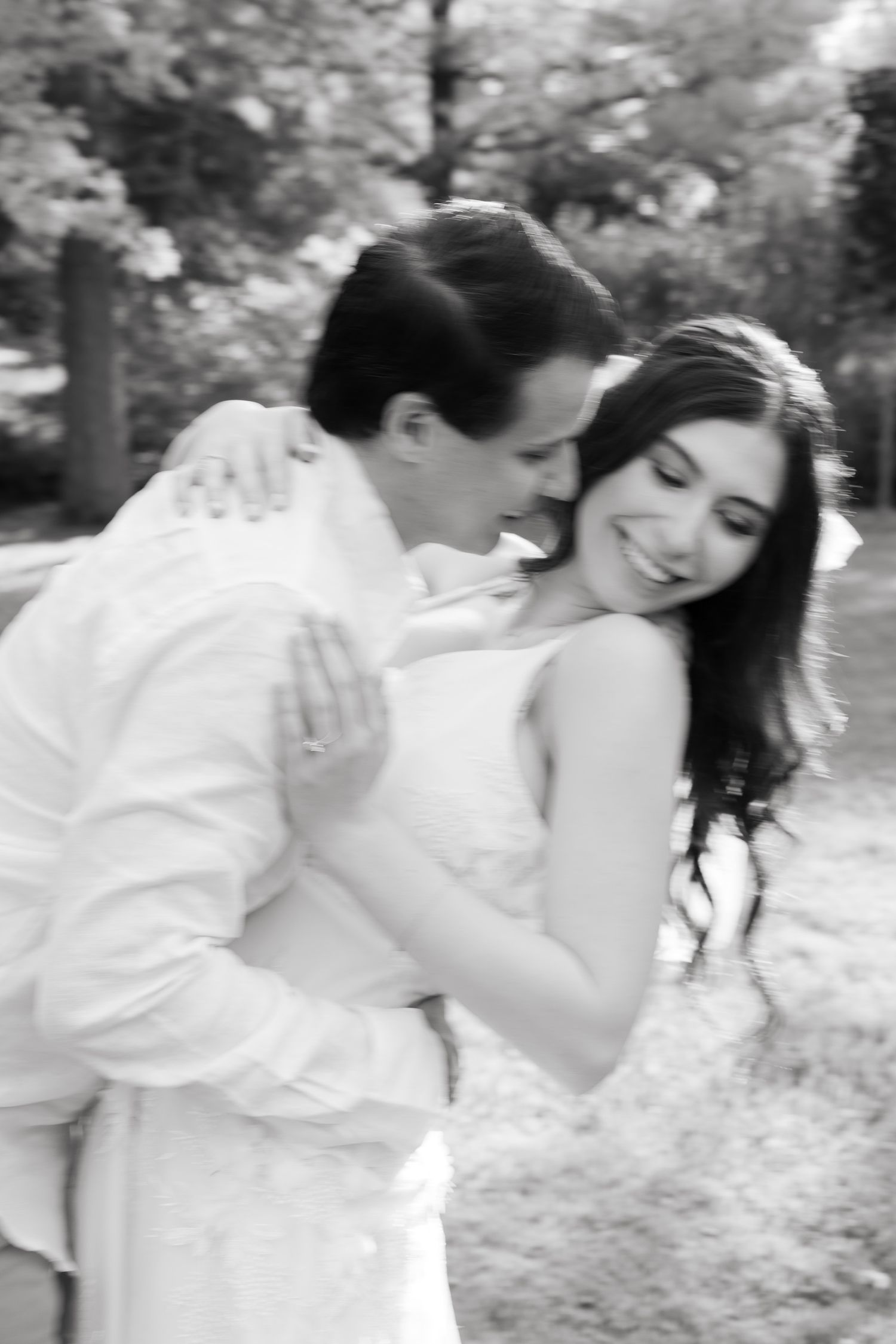 Black and white portrait capturing a romantic embrace between newlyweds.