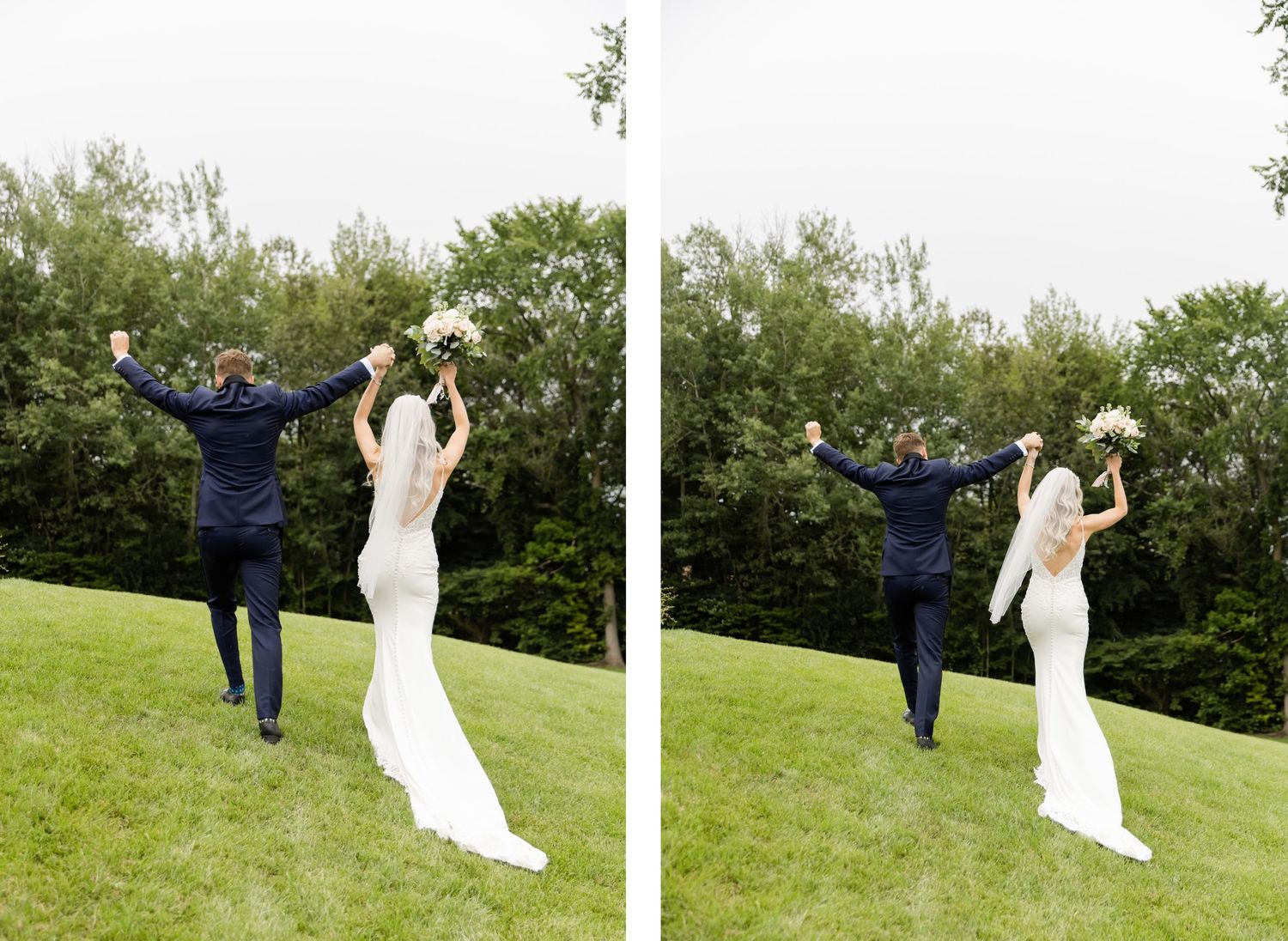 Joyful wedding couple leaps into the air on grassy lawn with trees in background.