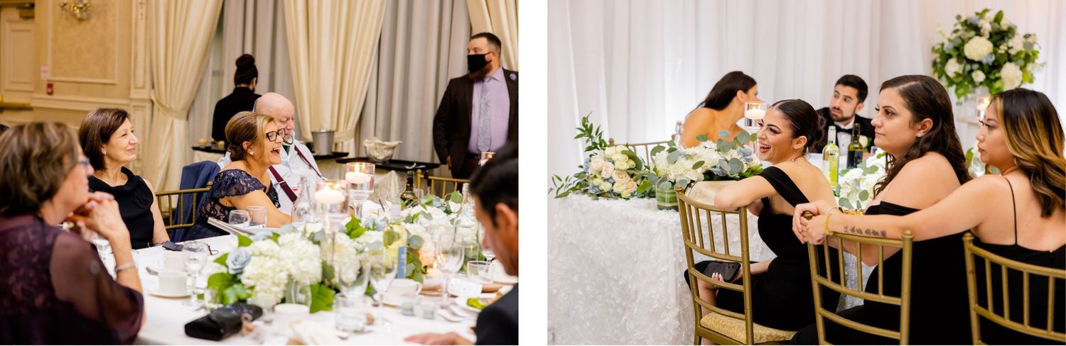 Reception guests enjoying dinner conversation at tables decorated with white floral arrangements.