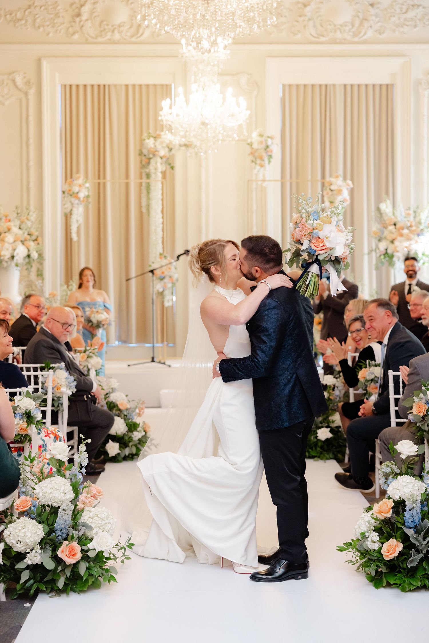 A romantic wedding sequence showing a couple performing a dip kiss at their elegant reception with floral decor.