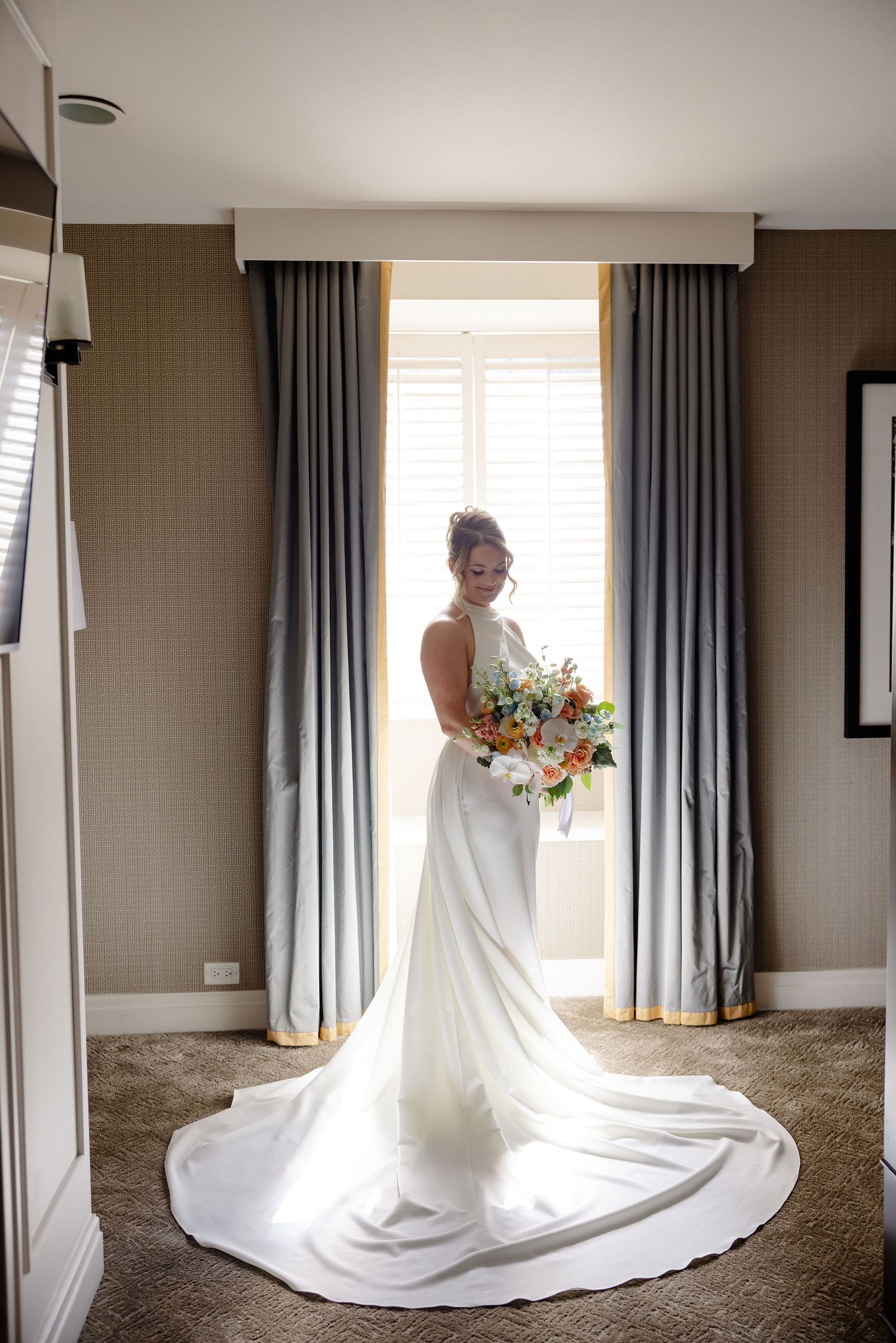 A series of elegant bridal portraits showing the flowing train of a white wedding gown in natural window light.