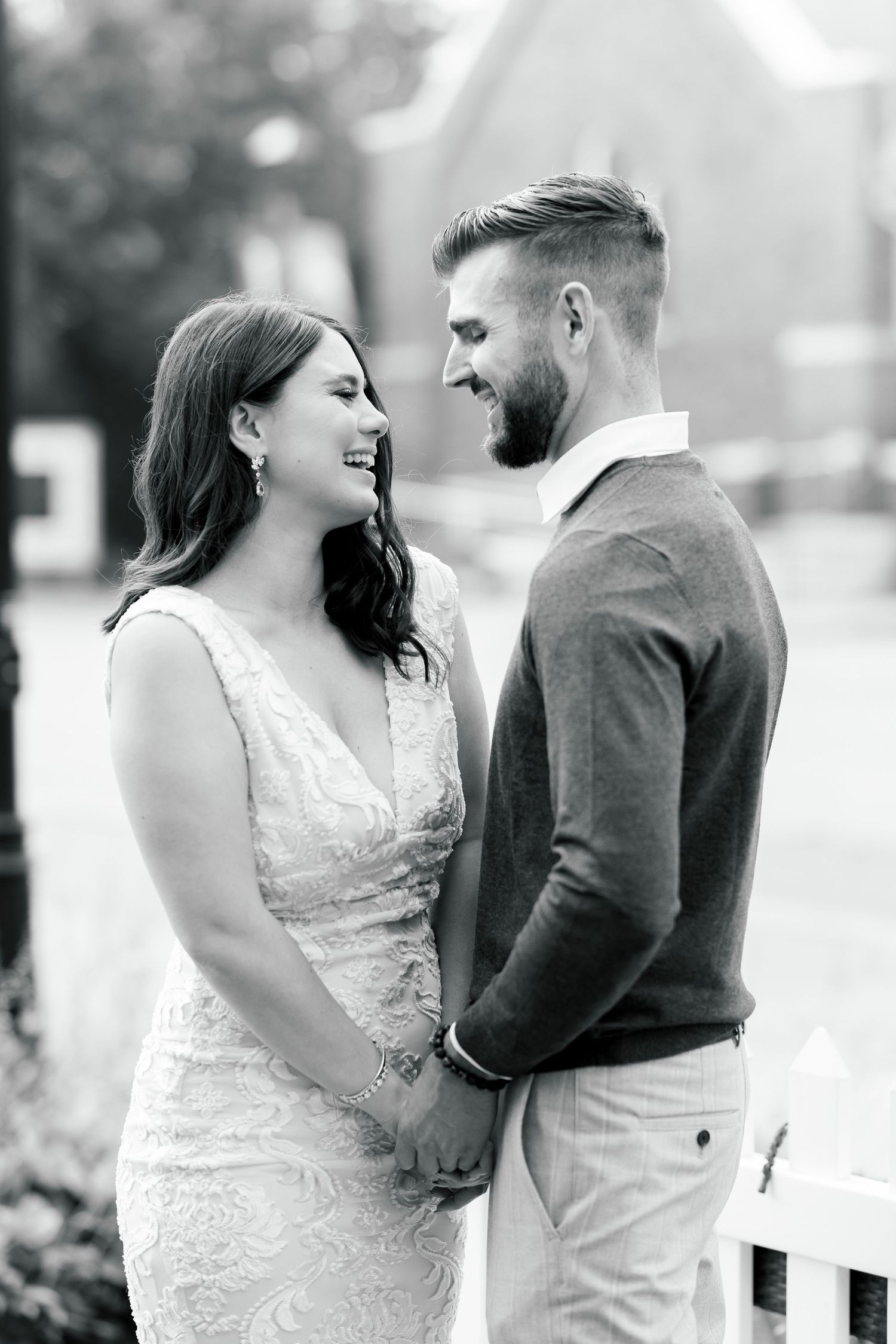 Black and white portrait of couple sharing intimate moment in formal attire.