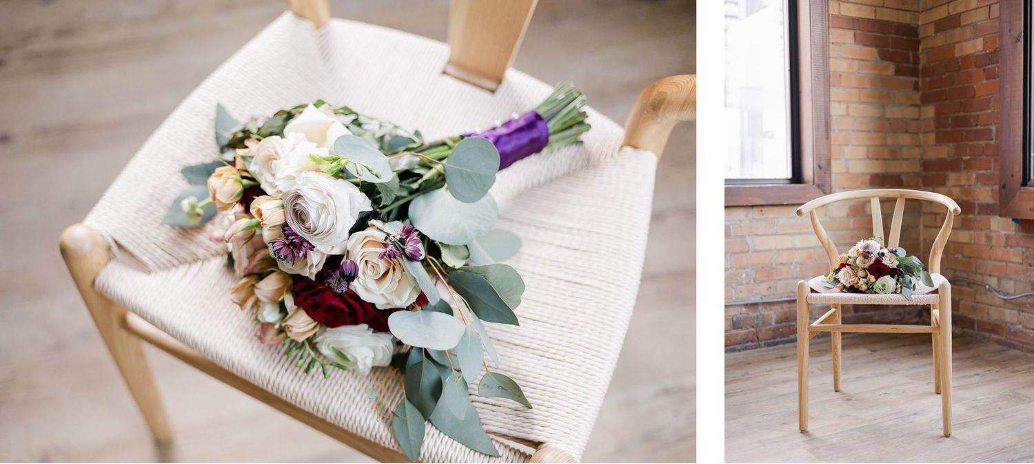 A romantic wedding bouquet with white and purple flowers rests on a chair in a rustic setting.