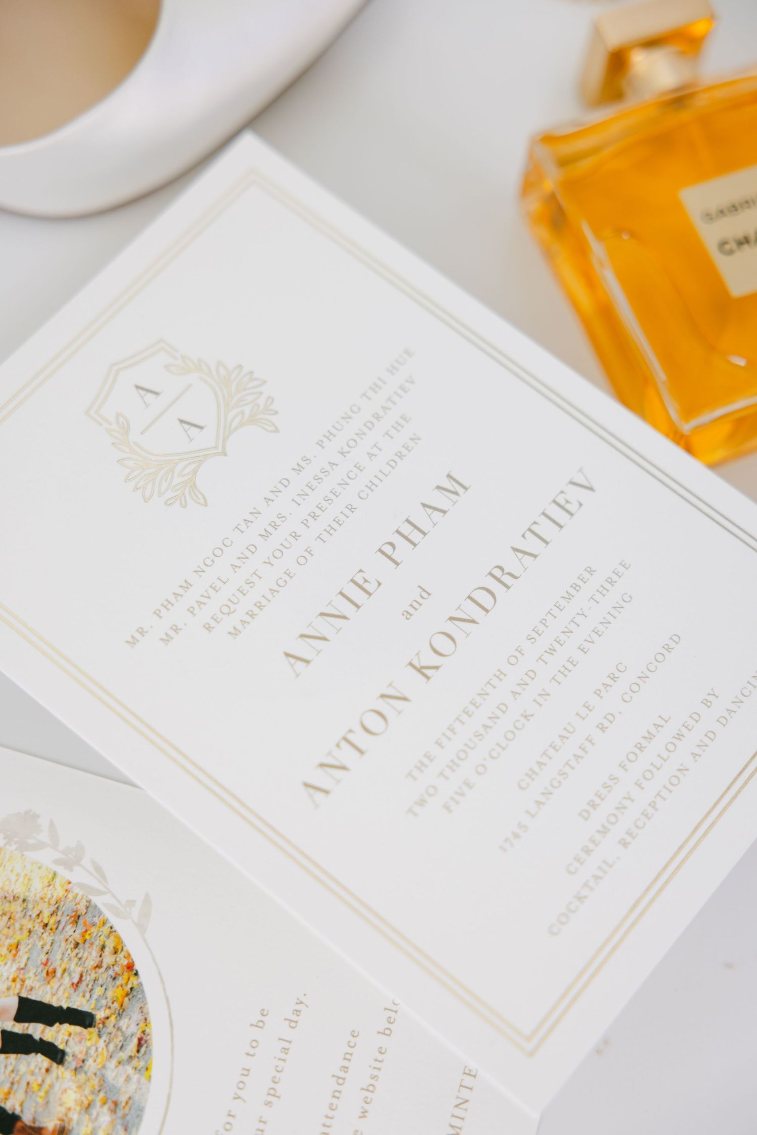 Close-up of elegant wedding invitation with gold monogram details.