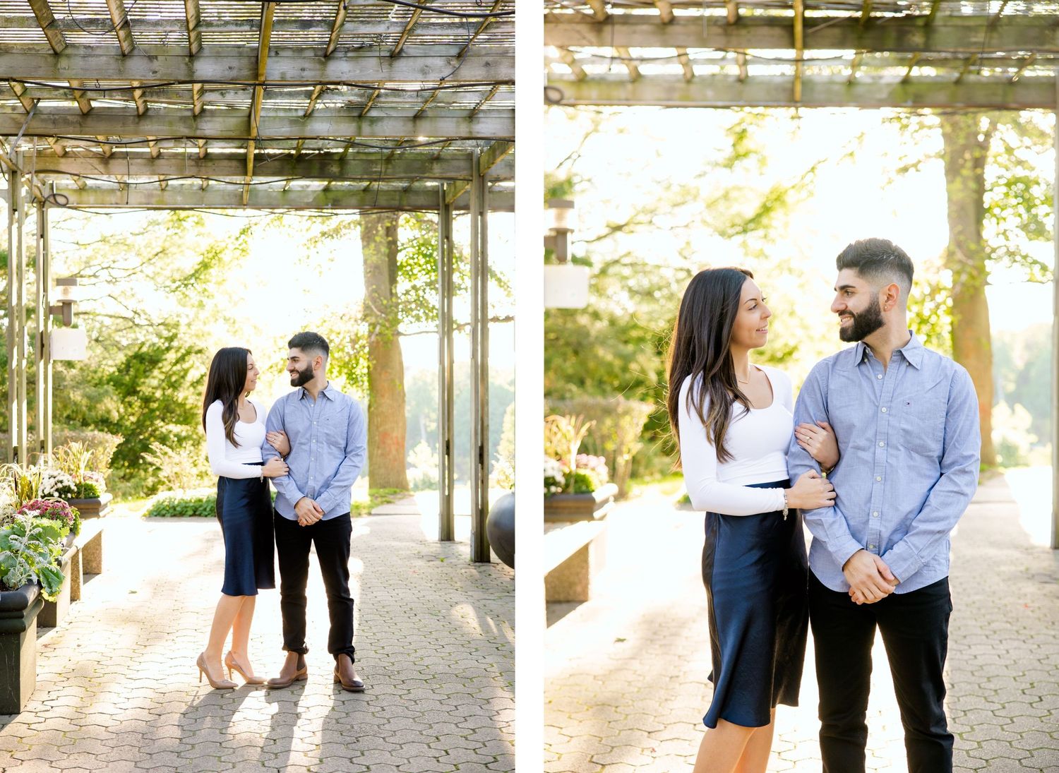 Couple poses beneath pergola in casual attire during outdoor photo session.