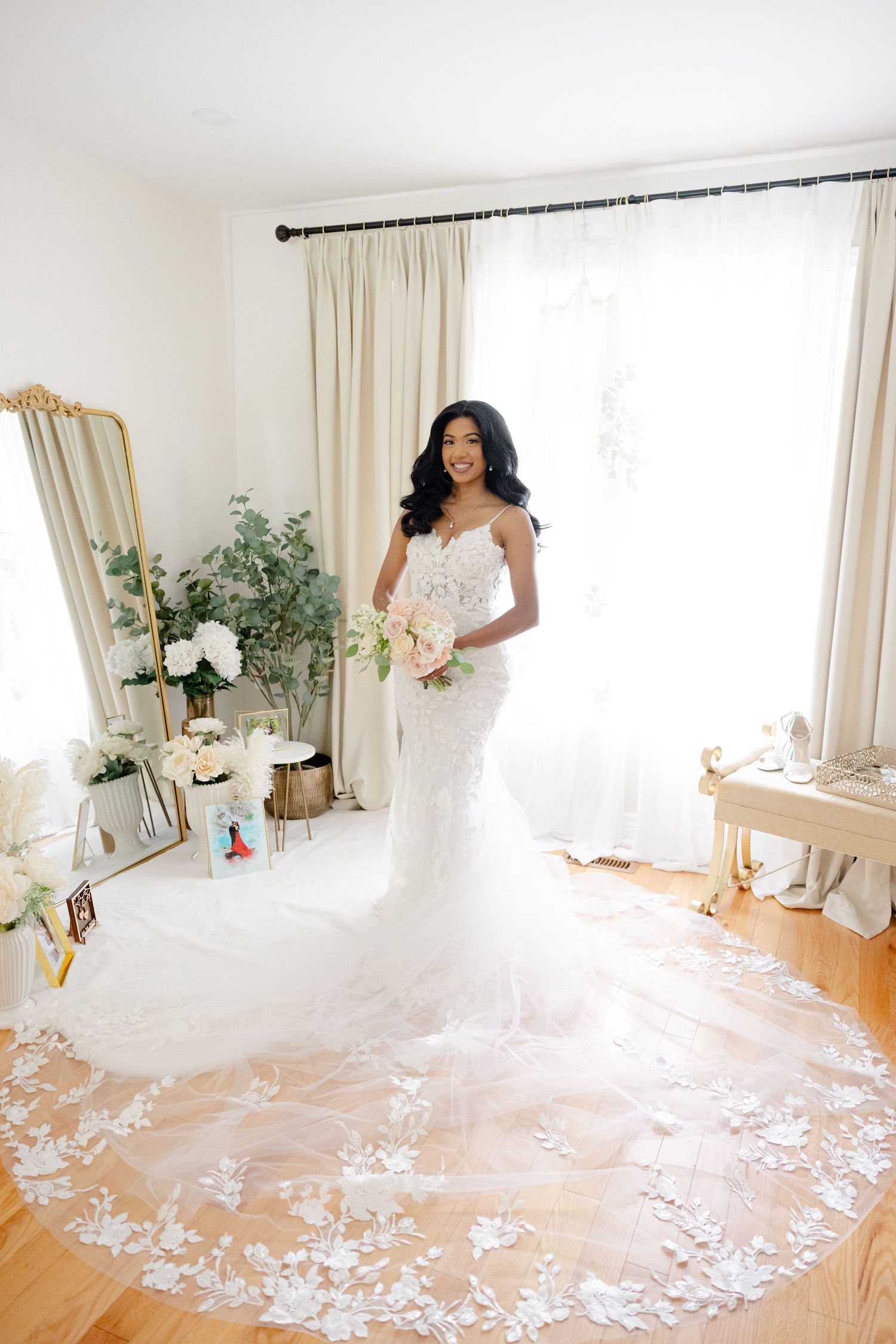Stunning full-length bridal portrait showcasing an intricate lace wedding gown with cathedral train.