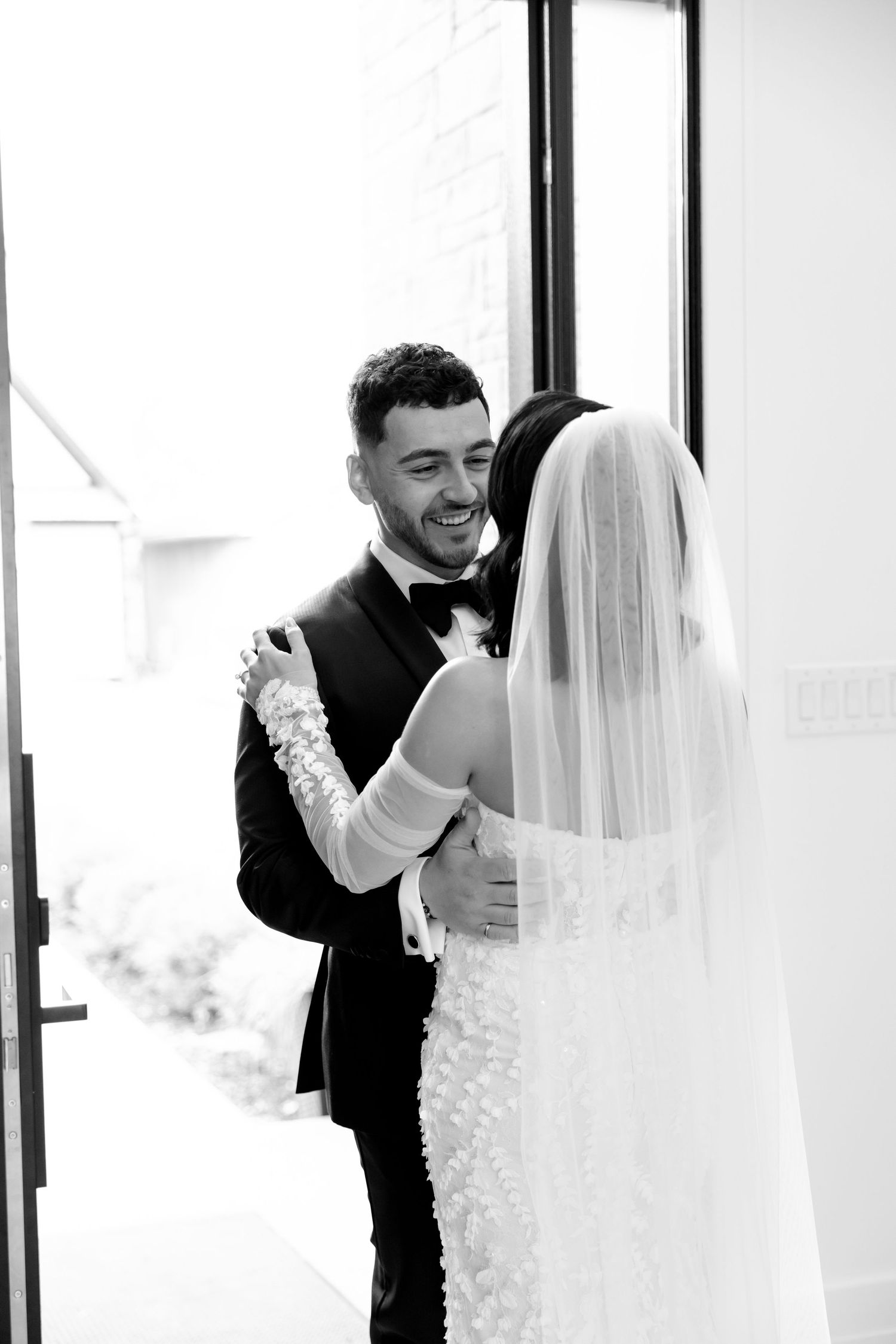 An intimate first look moment between newlyweds at their modern venue.