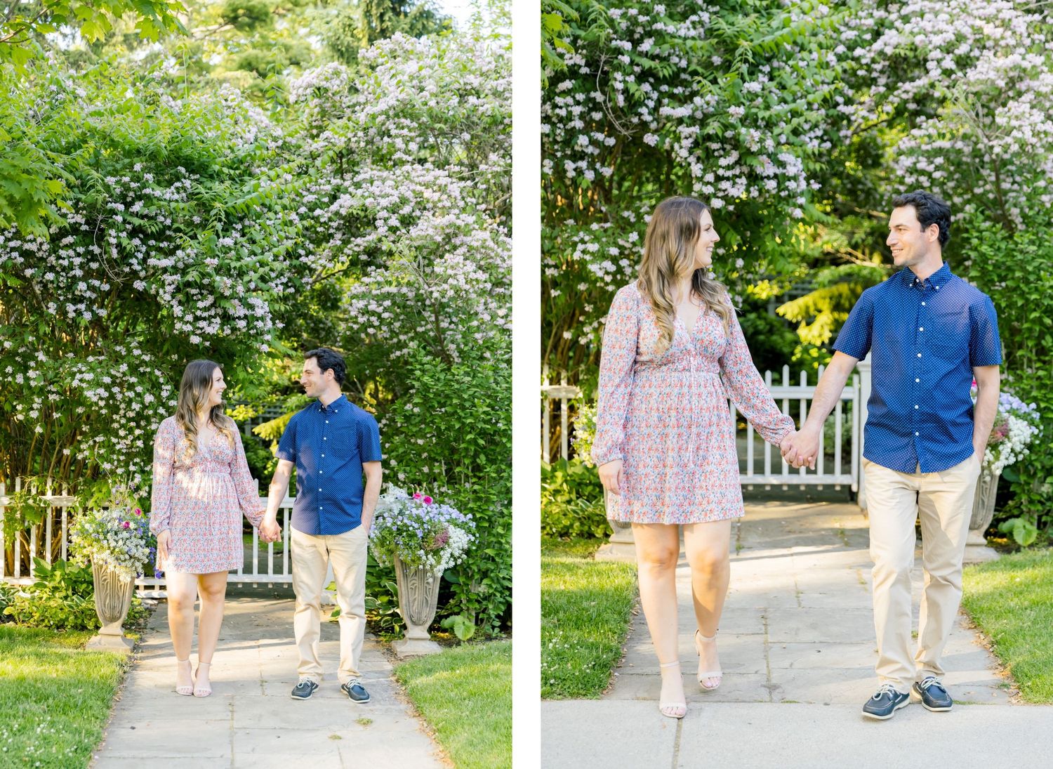 A couple strolls along a garden path with blooming white flowers and greenery in the background.