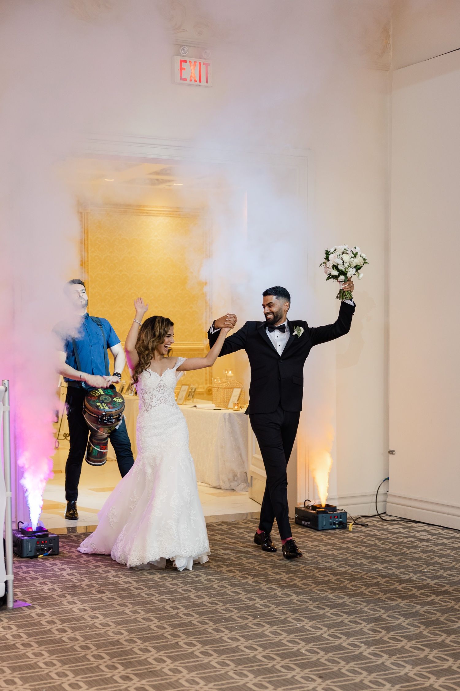 Wedding celebration moment in a ballroom with dancing and celebration.