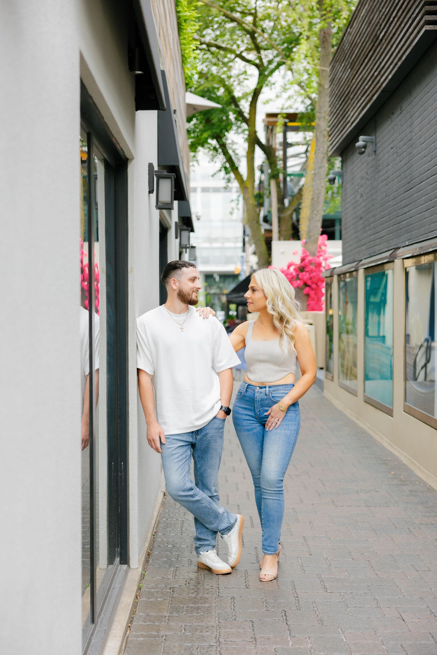 A couple in matching casual outfits walking together on a modern urban pathway.