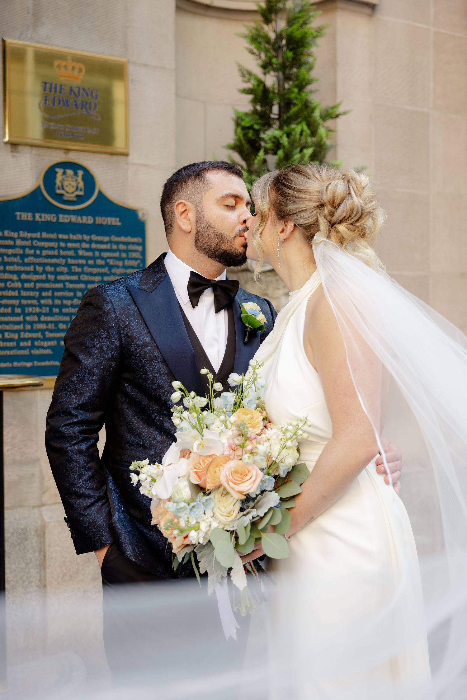 Romantic wedding portraits captured against the stone walls of a luxury hotel.