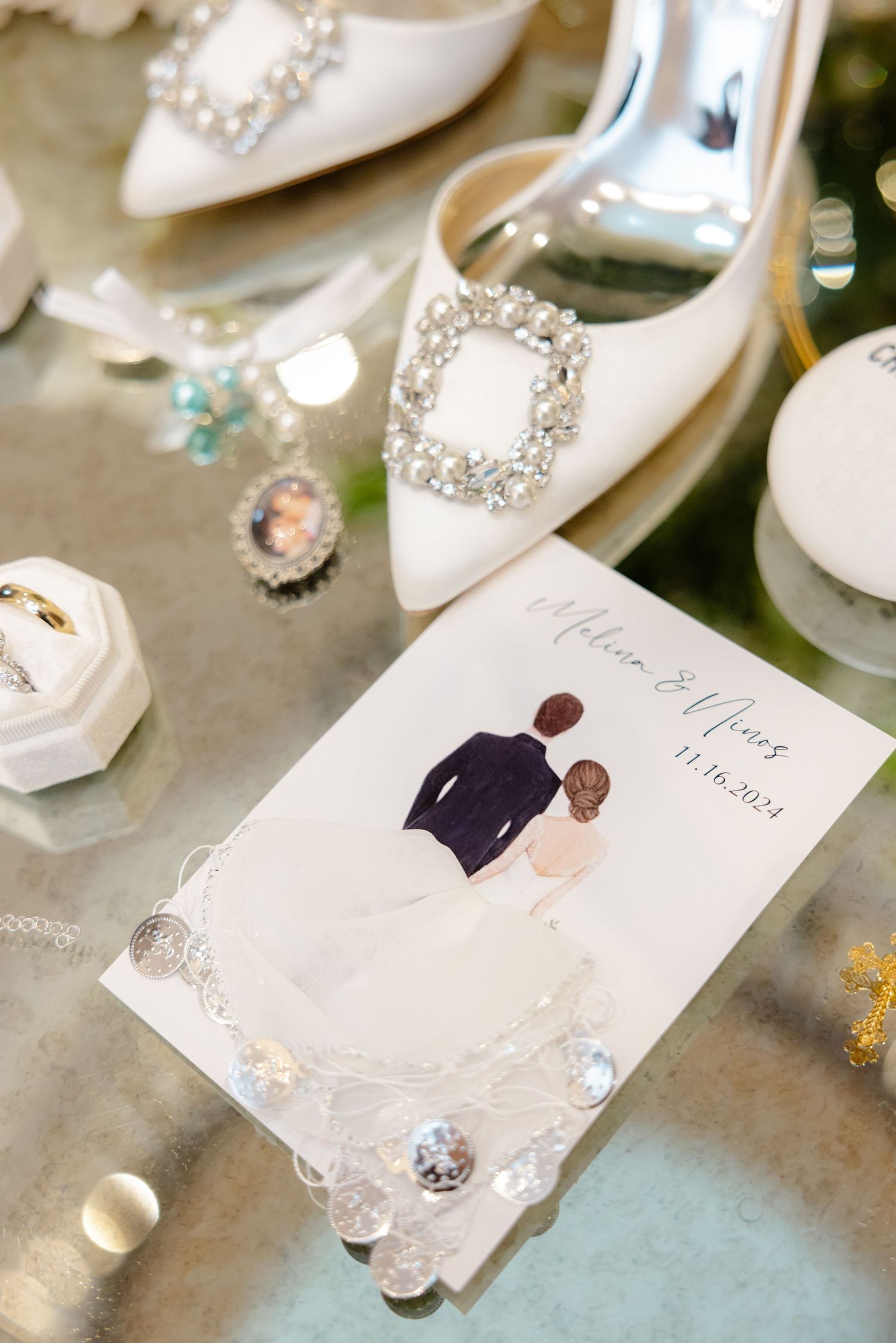 Wedding accessories including white bridal shoes and invitation card with couple illustration.