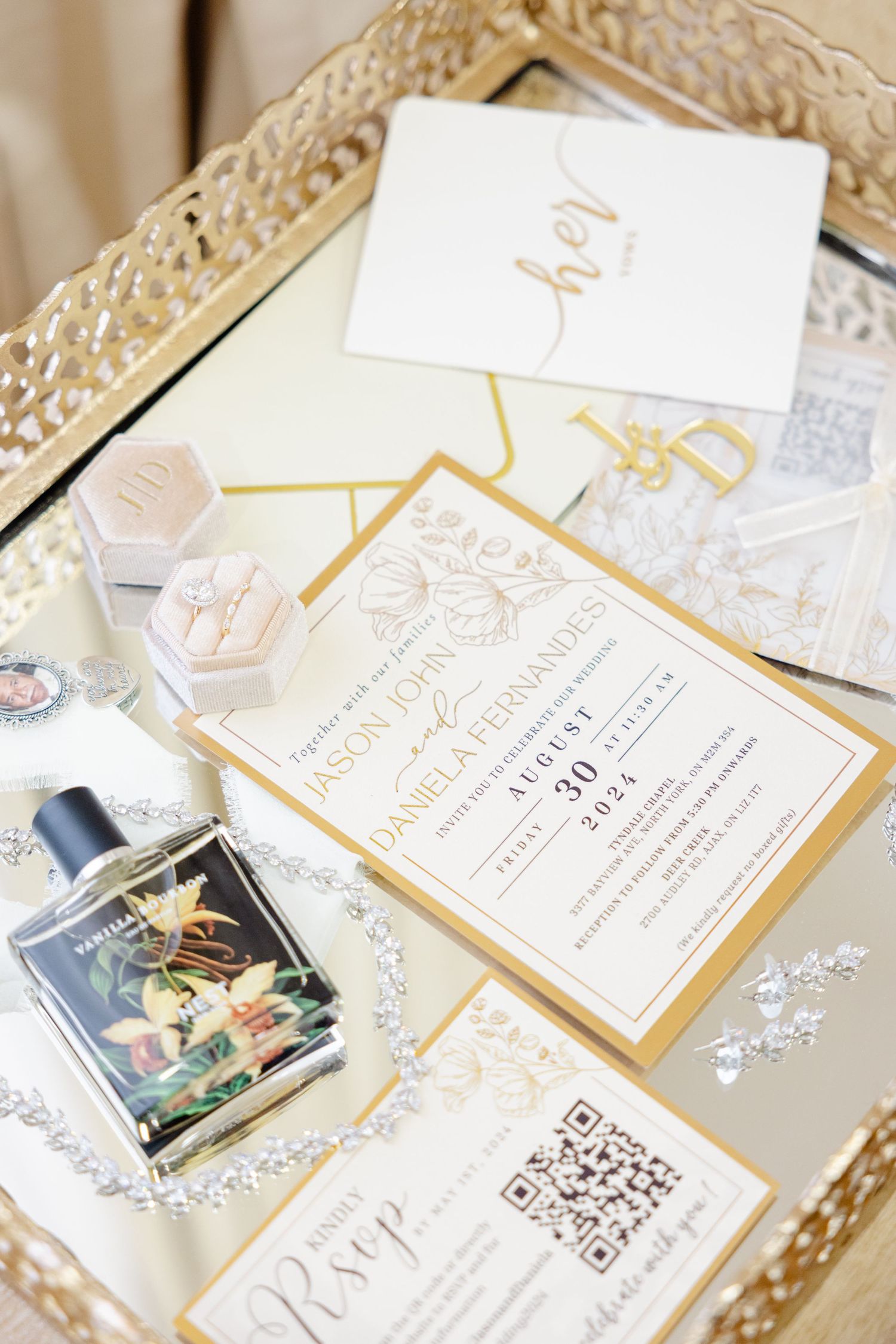Elegant wedding stationery set with gold details and monogram in decorative tray.