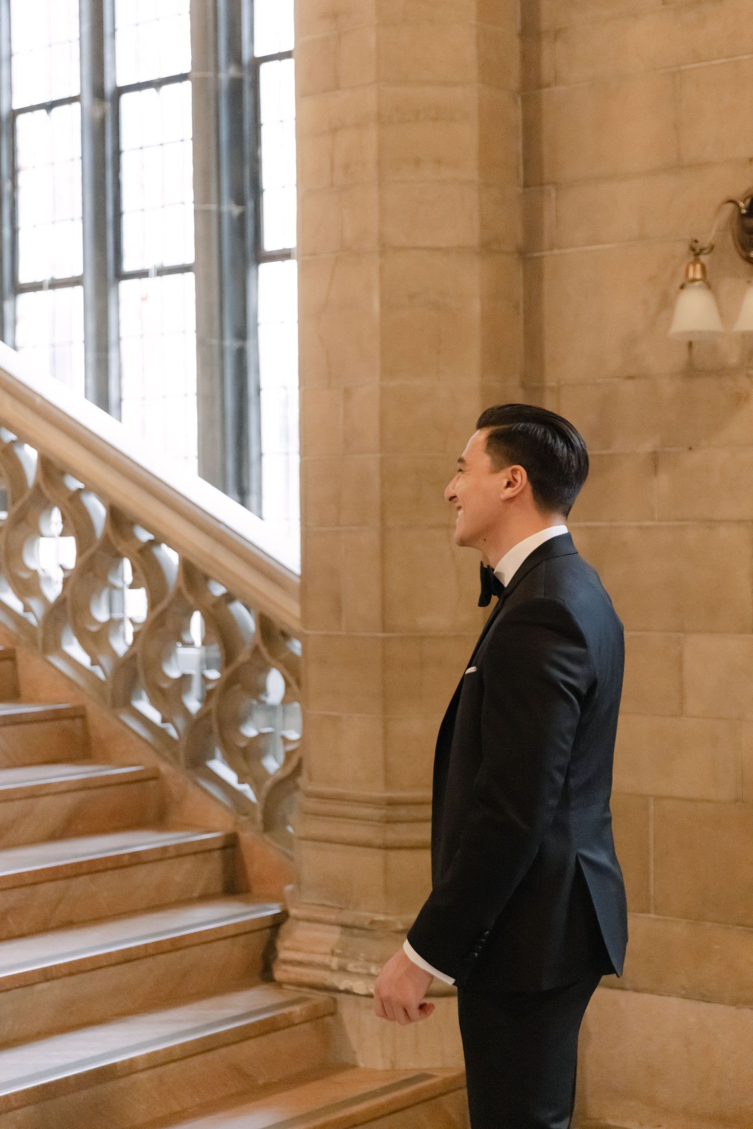 Side profile shot of formal attire against classic stone architecture and staircase.