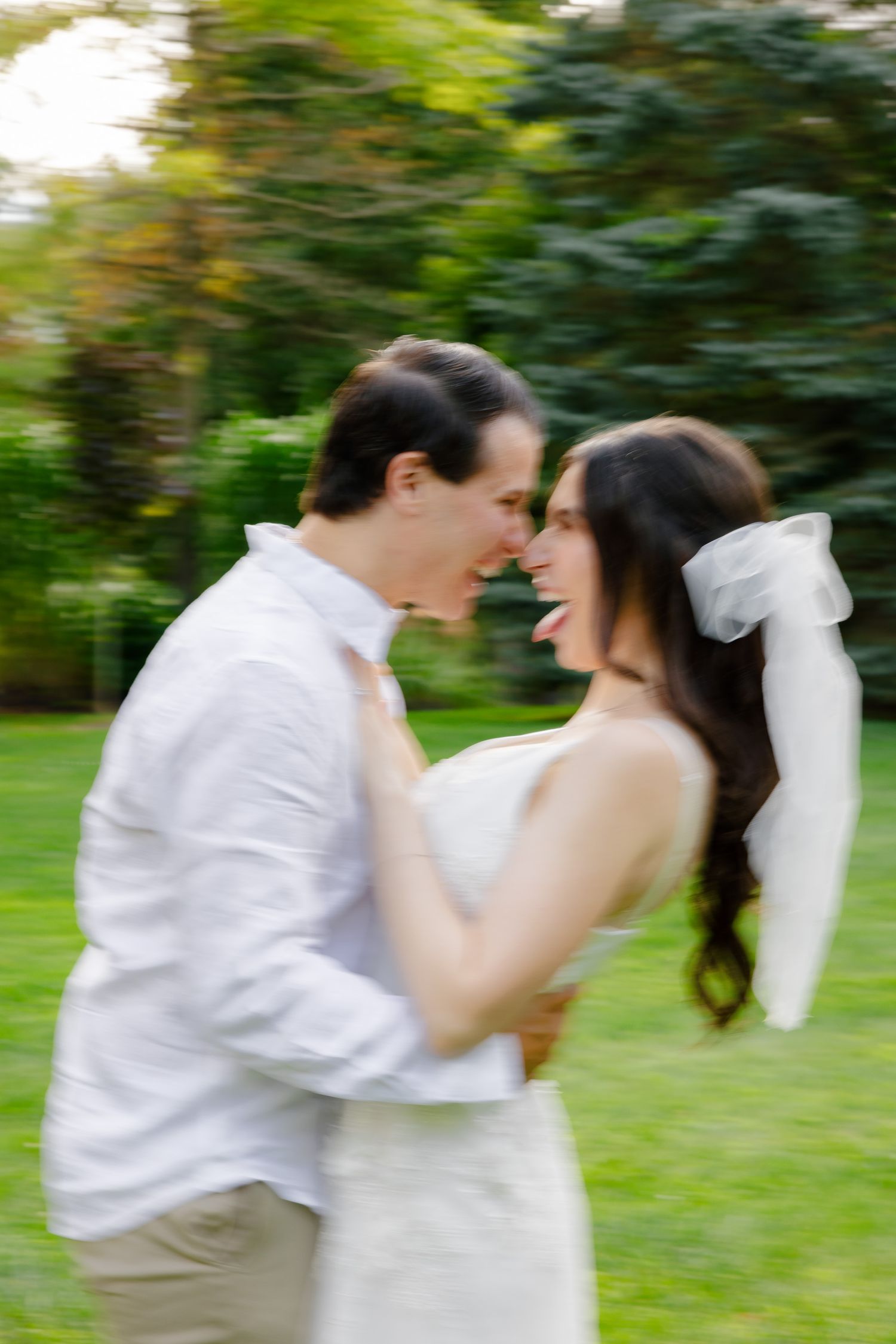 A motion-blurred romantic moment between a couple in a garden.