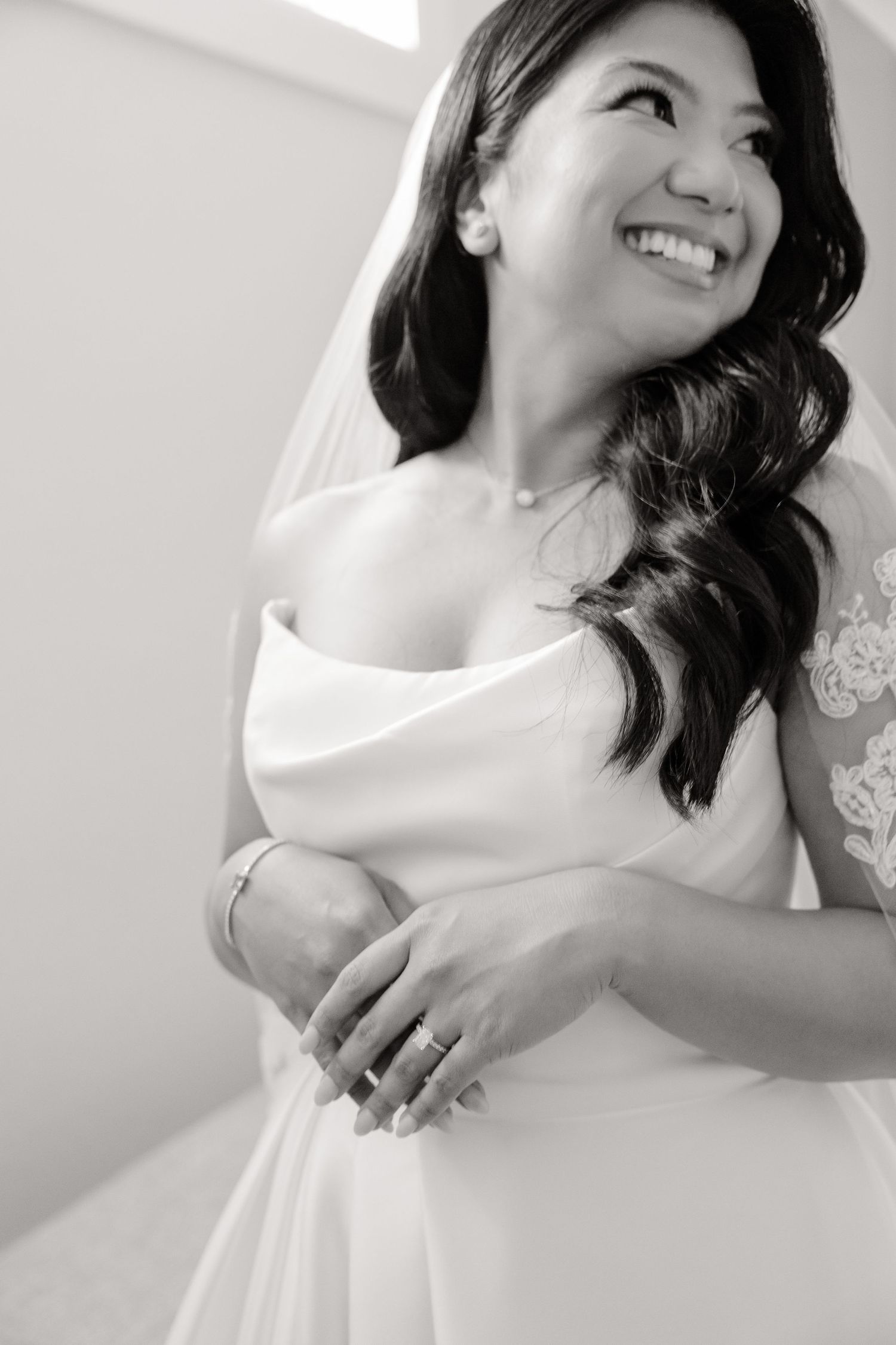 Side profile portrait of bride in strapless wedding gown with soft wavy hair.