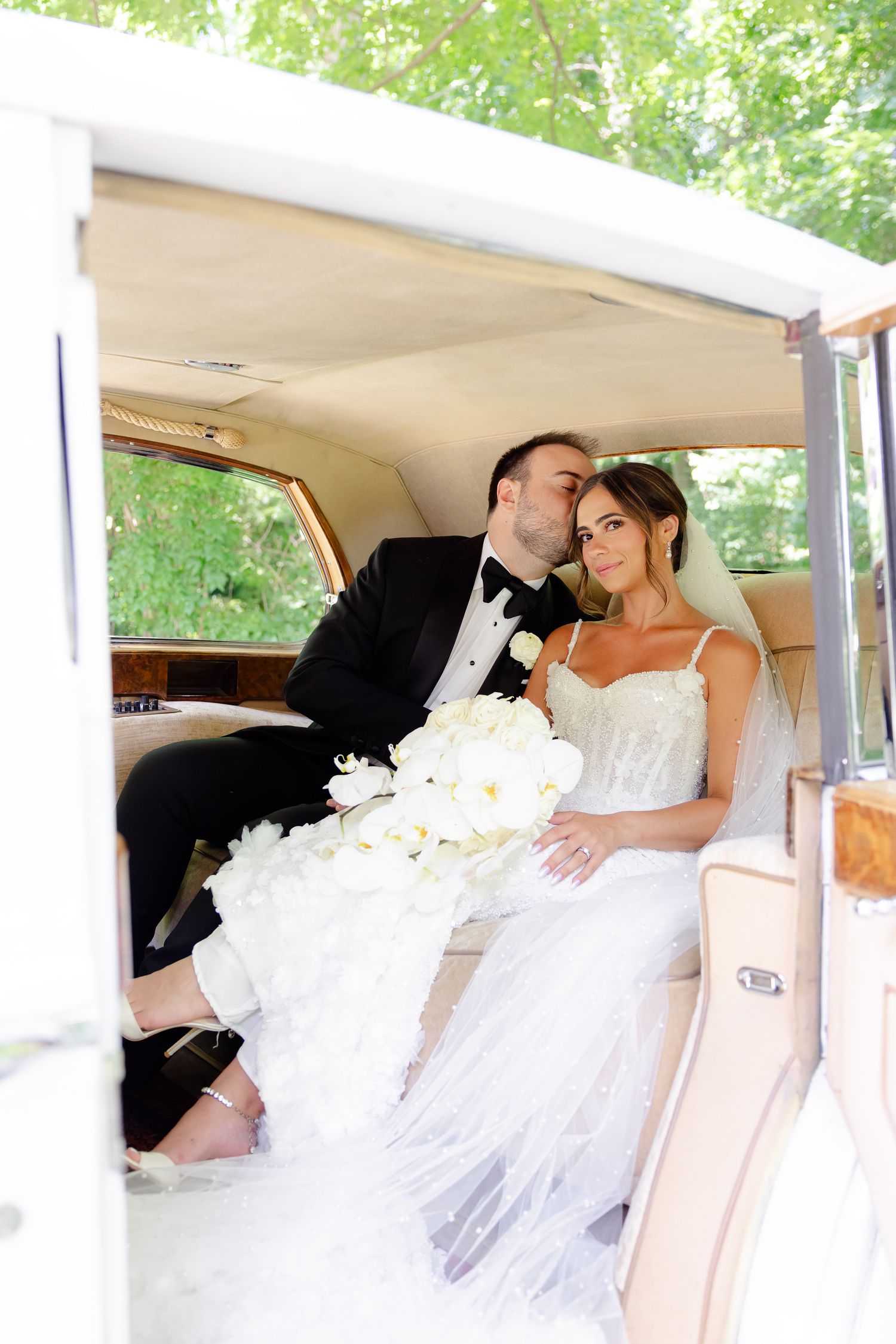 A series of photos showing a bride in a white wedding dress reclining in the backseat of a luxury car.