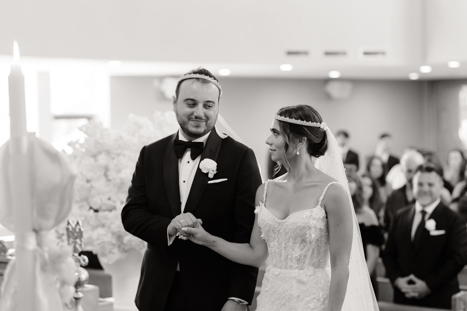 A wedding moment captured in black and white during a joyous ceremony celebration.