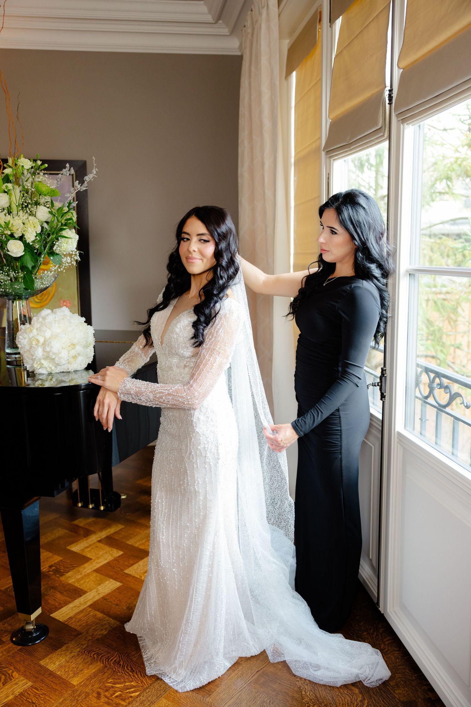 Wedding dress preparation scene with flowing train and dramatic window lighting.