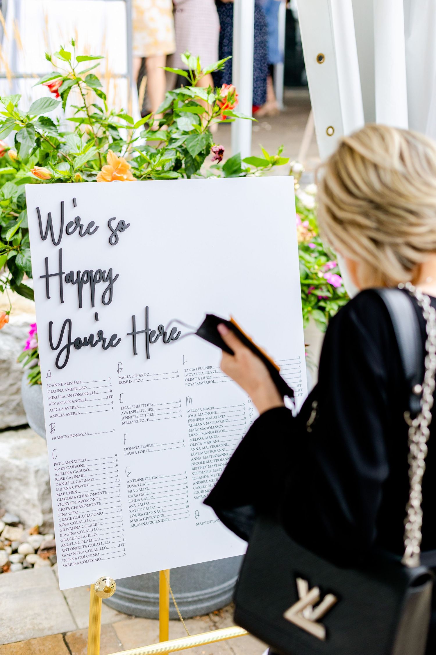A welcome sign with floral decorations displayed at an outdoor event.