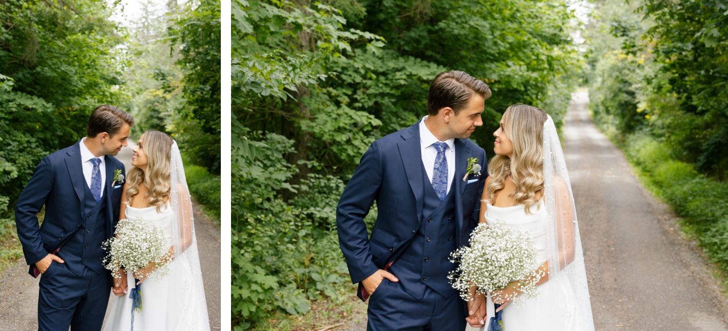 Wedding couple shares a romantic moment on a tree-lined path in their formal attire.