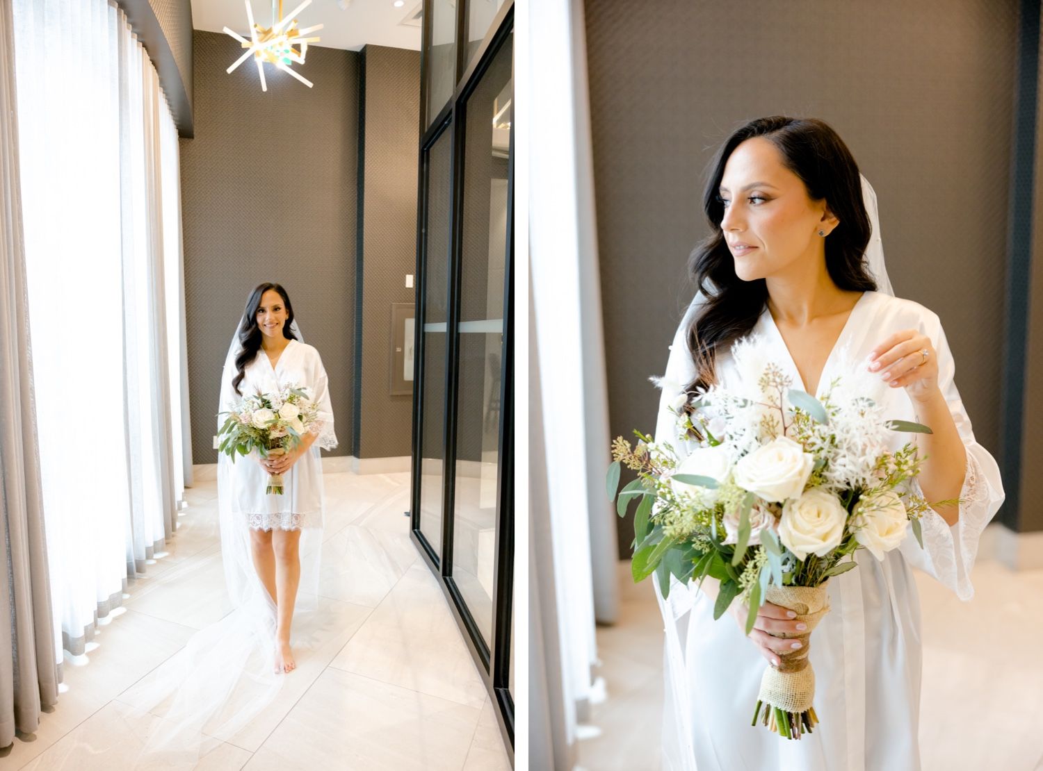 Bride in white robe holding elegant bouquet walks down sunlit hallway.