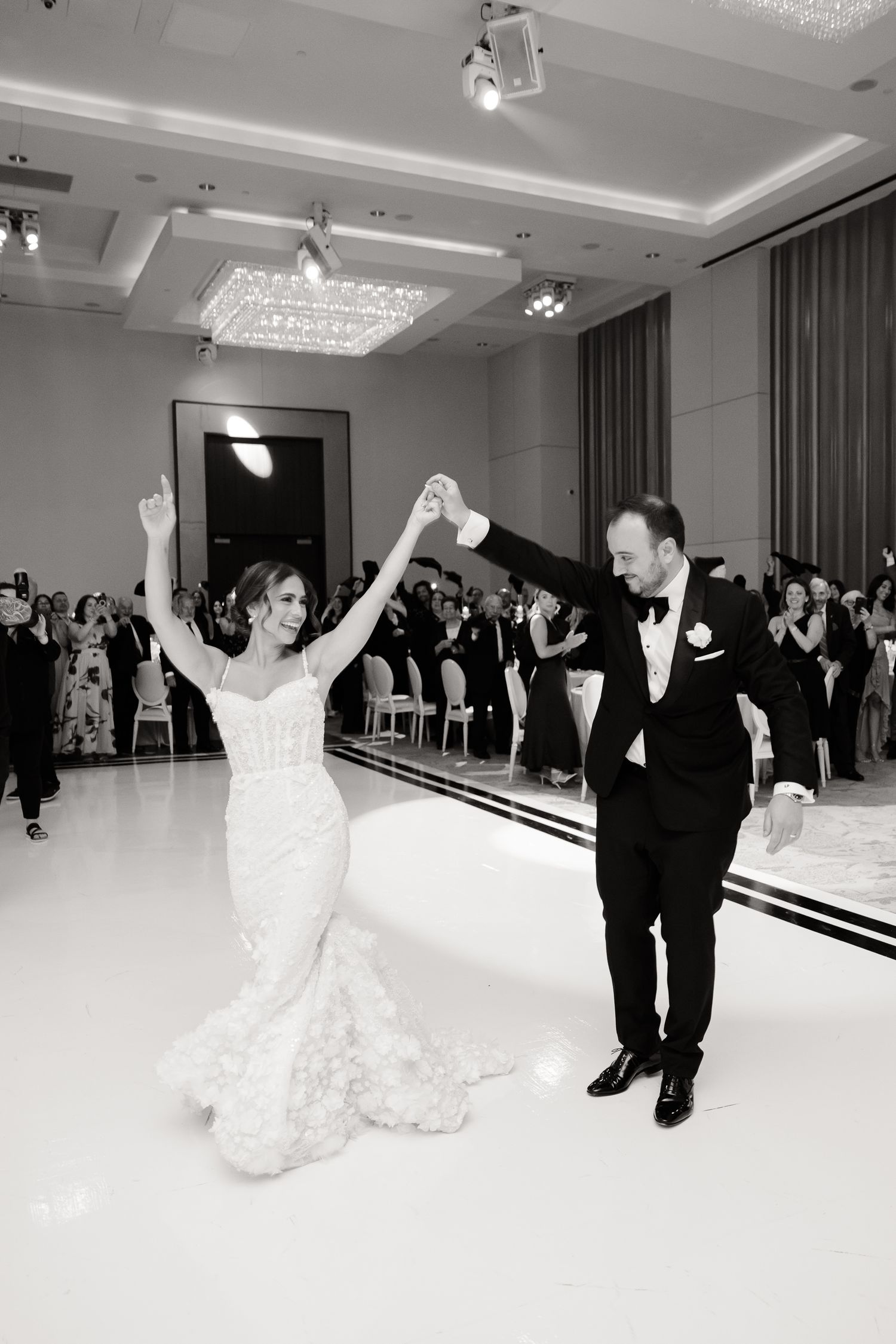 Black and white sequence of a bride and groom performing a dramatic dance spin at their wedding reception.