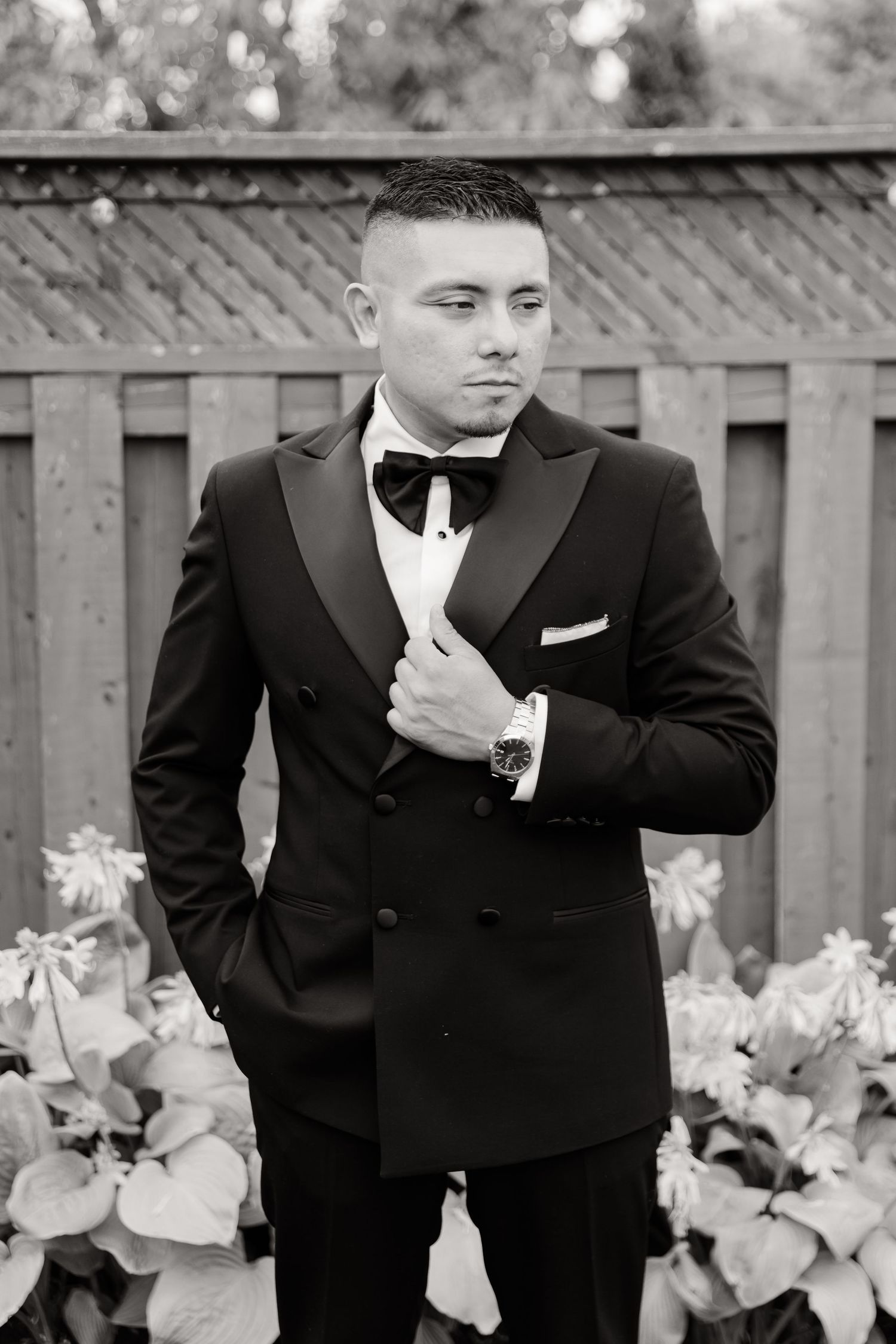 A sequence of photos shows a man in a black tuxedo making playful expressions and gestures in front of a wooden fence.