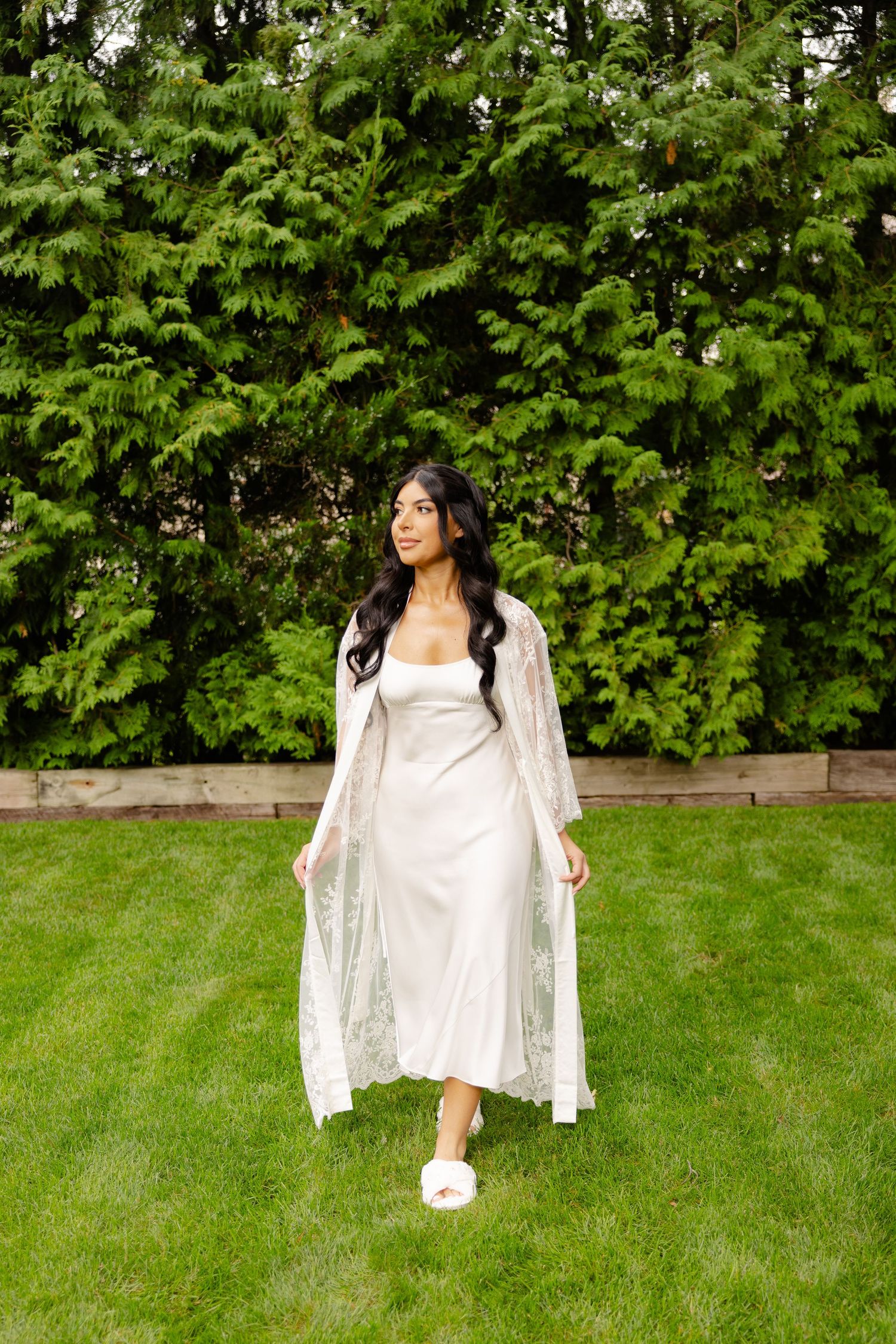 A sequence of images shows a figure in white clothing posed artistically against a lush green garden backdrop.