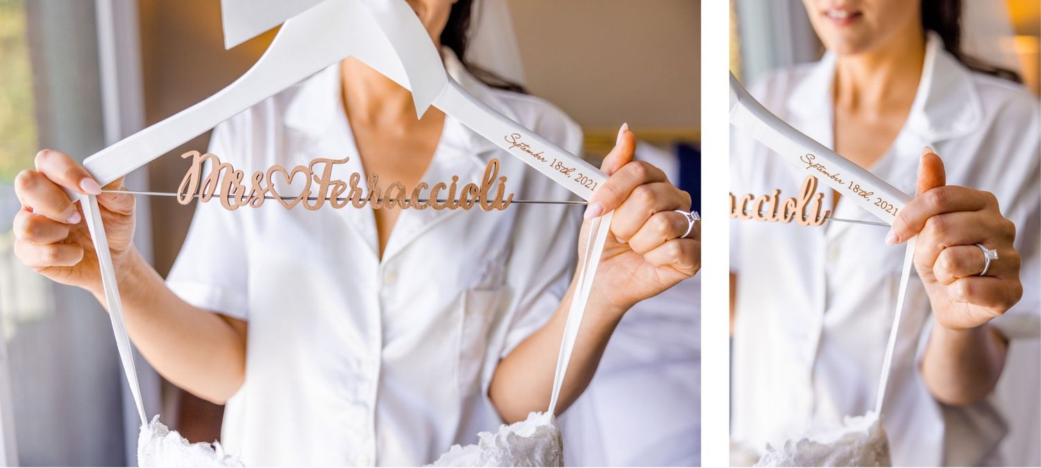 Gold personalized wedding dress hangers being held up to display custom lettering.