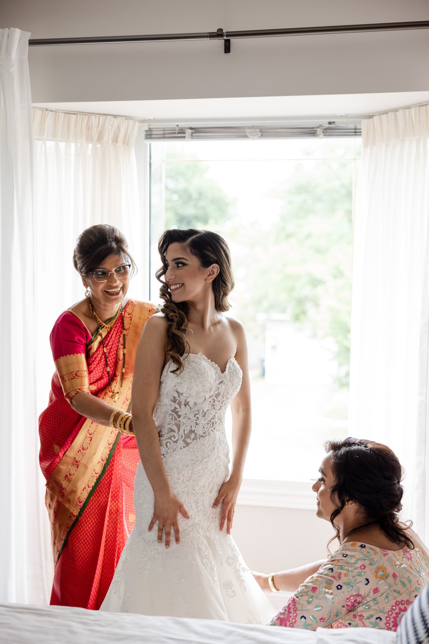 Final wedding dress fitting and preparations in sunlit room.