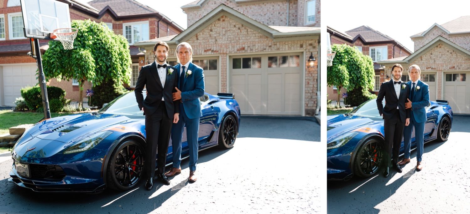 Two figures in formal attire pose beside a sleek blue sports car in a driveway.