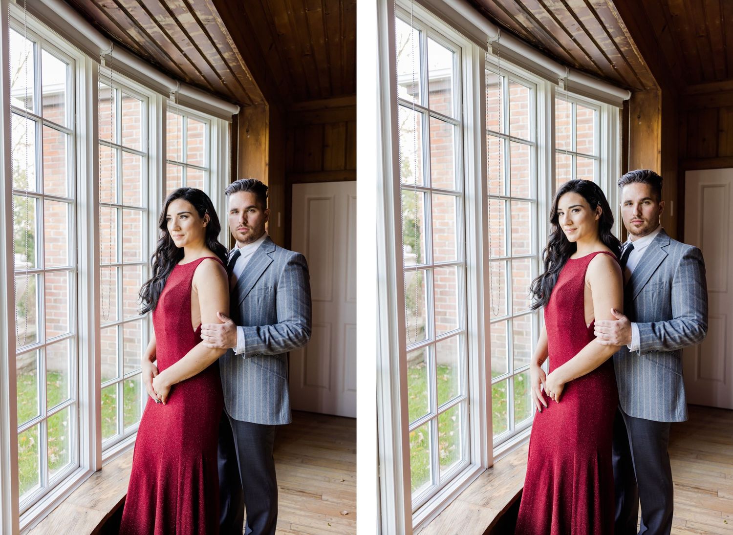 Romantic couple portrait by window with woman in red dress and man in grey suit.