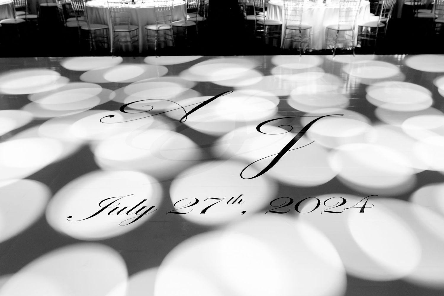 Wedding date projected in circular light patterns on the floor.